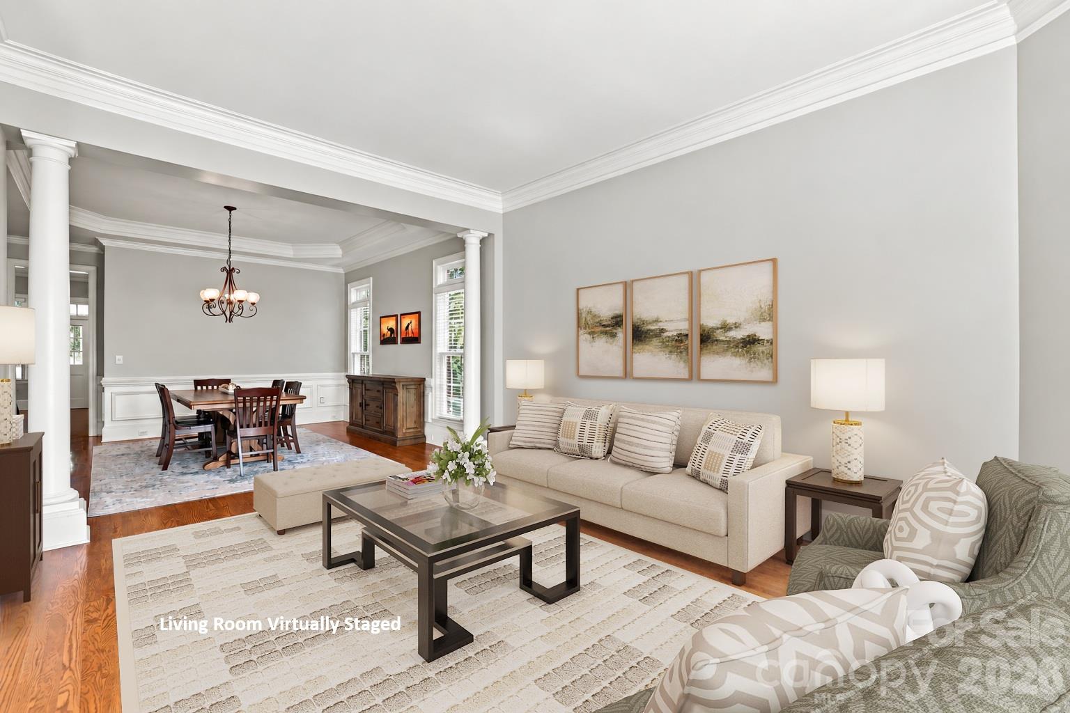 Formal does not have to mean closed off. The living and dining rooms flow directly into one another, giving you two distinct spaces for entertaining that work beautifully together. - 2309 Highland Forest Drive, Waxhaw