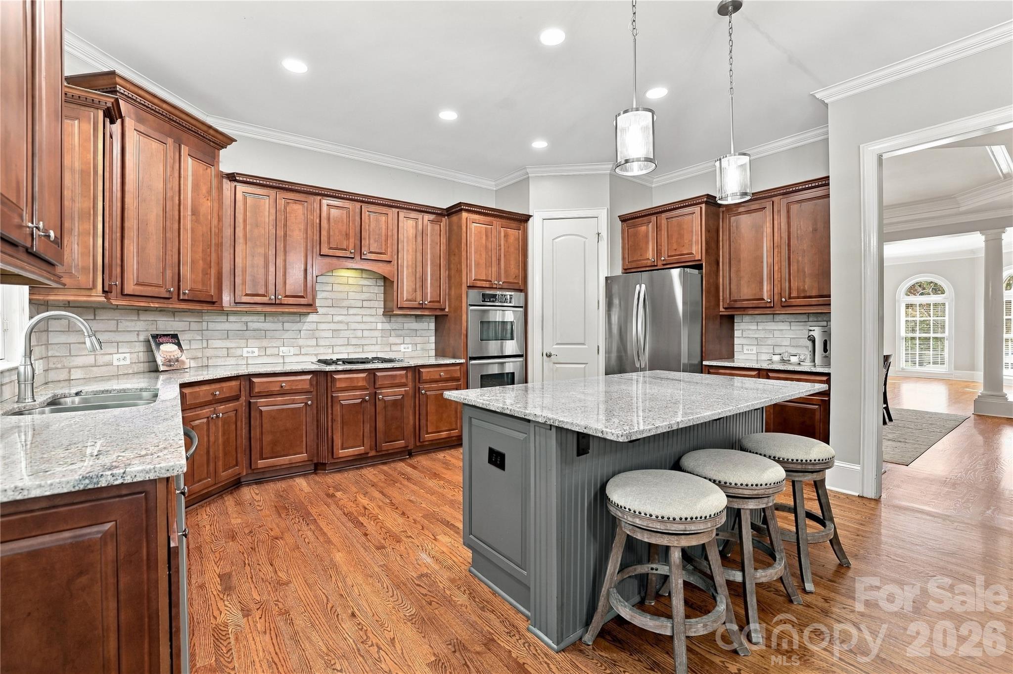 Whether you’re preparing dinner for two or cooking for a houseful, this kitchen gives you the space to do it without feeling crowded. The granite island provides an expansive prep area while seating for three makes it easy for friends and family to pull up a stool and keep the cook company. - 2309 Highland Forest Drive, Waxhaw