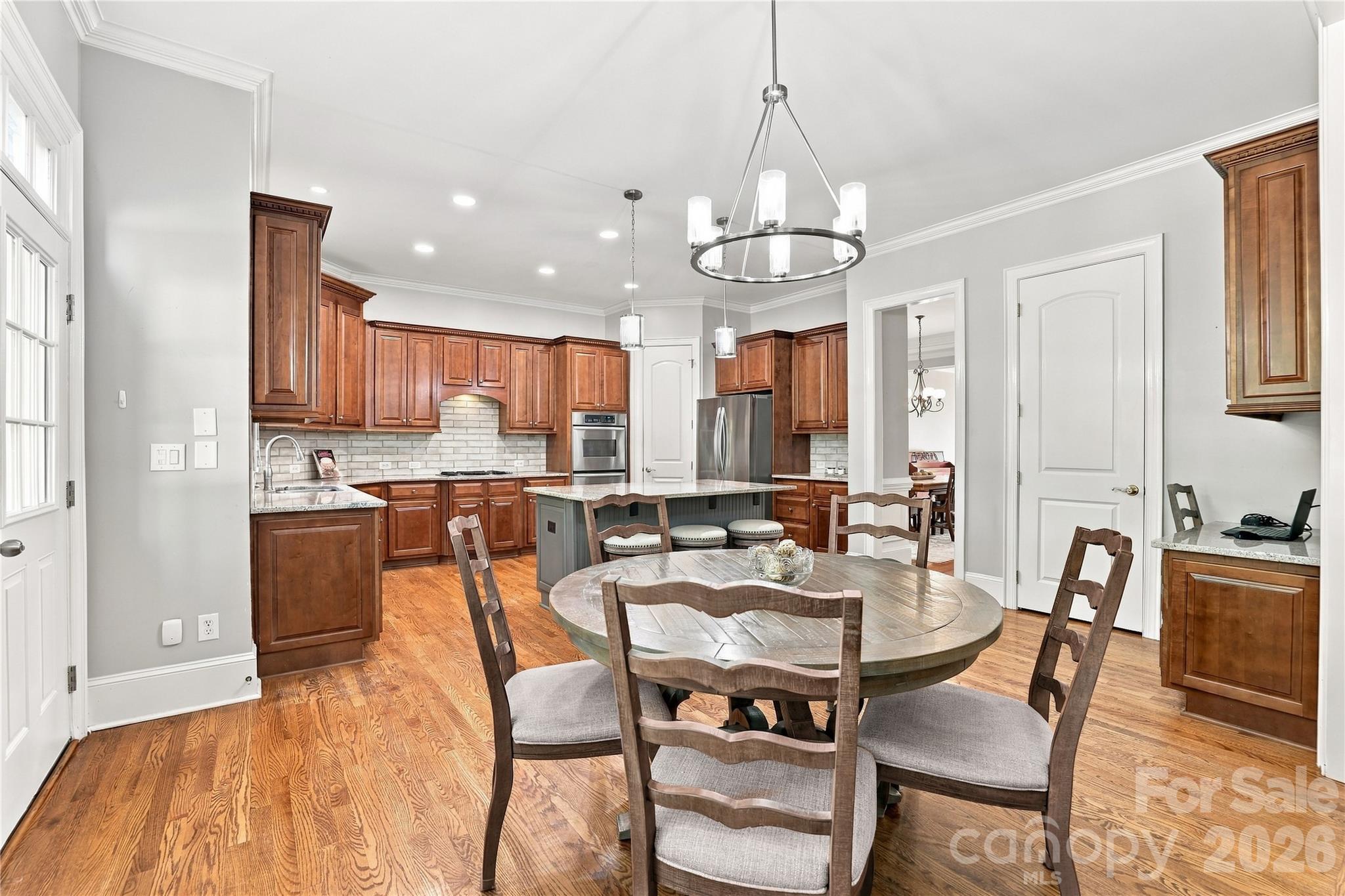 More than a breakfast nook, this spacious casual dining area easily accommodates a full-size table with plenty of room for everyday meals, leisurely weekend breakfasts or a table full of family and friends — all just steps from the kitchen. - 2309 Highland Forest Drive, Waxhaw