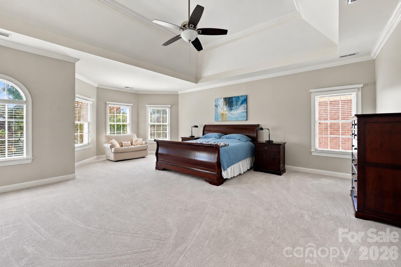 The primary suite has the scale you expect in a home of this caliber, with plenty of room for a king-size bed and substantial furniture. The vaulted tray ceiling adds architectural drama while the bay window creates a natural sitting area for reading, relaxing or enjoying a quiet start to the day. - 2309 Highland Forest Drive, Waxhaw
