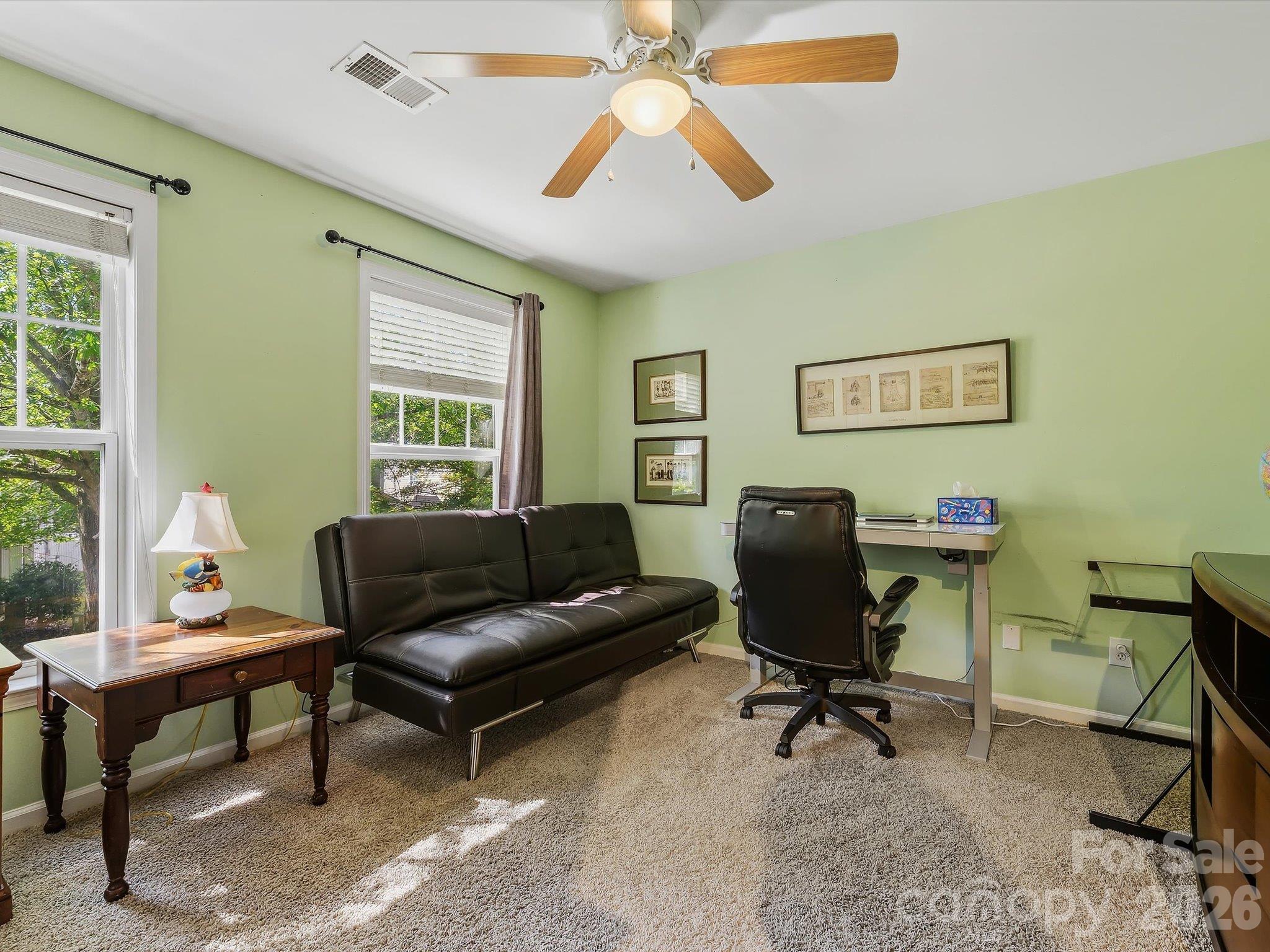 Bedroom 3 offers a bright, flexible layout with abundant natural light, ideal for use as a bedroom, home office, or additional flex space. - 11732 Windy Mist Way, Huntersville