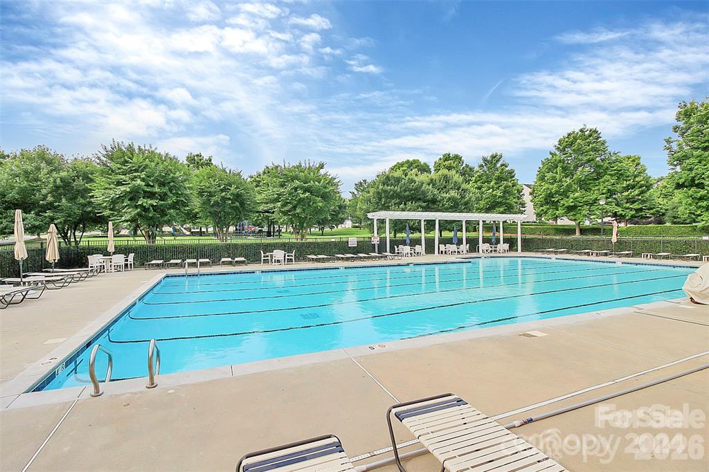 Tanners Creek community amenities include a spacious outdoor pool and clubhouse area with ample seating for relaxing and enjoying warm-weather recreation. - 11732 Windy Mist Way, Huntersville