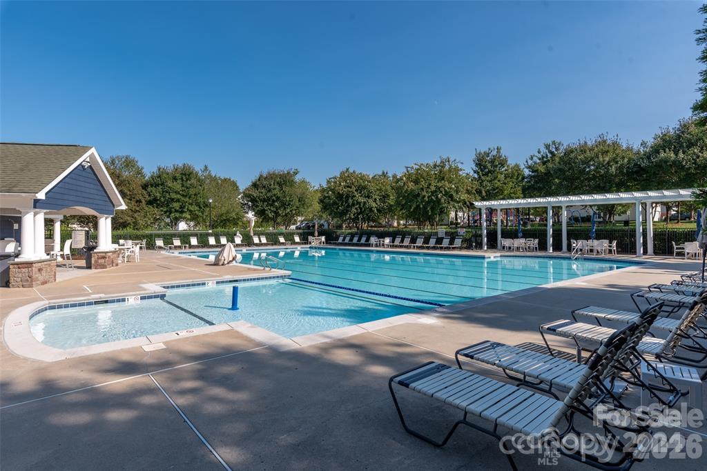 Tanners Creek community amenities include a spacious outdoor pool and clubhouse area with ample seating for relaxing and enjoying warm-weather recreation. - 11732 Windy Mist Way, Huntersville