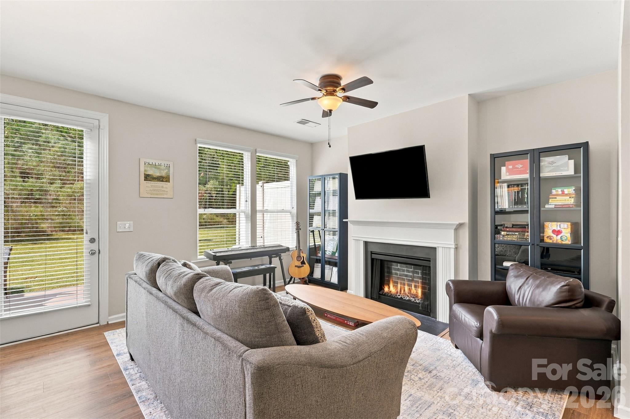 Cozy living room surrounded by a gas fireplace; great natural light! - 1020 Archibald Avenue, Fort Mill