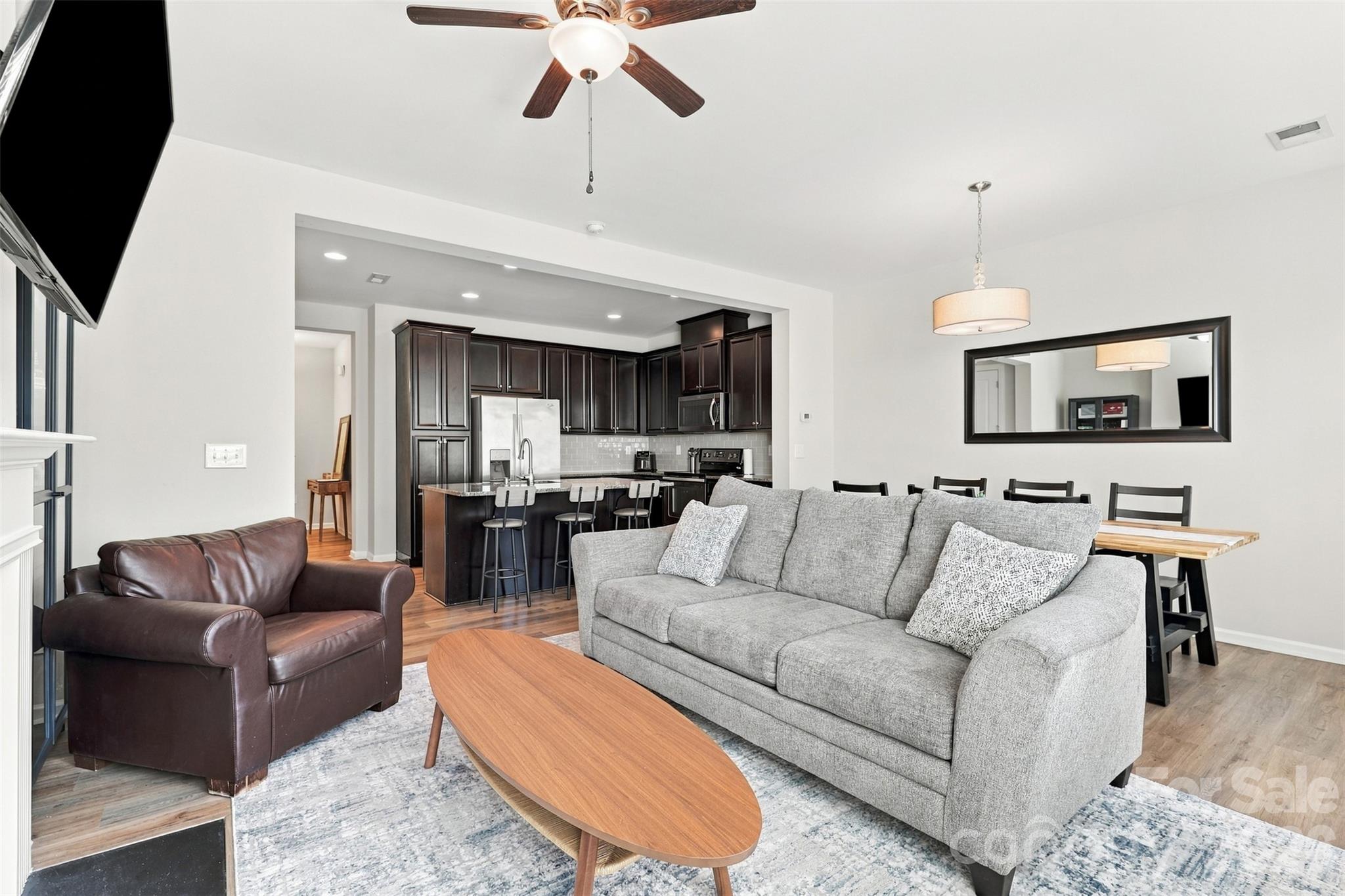 Cozy living room surrounded by a gas fireplace; great natural light! - 1020 Archibald Avenue, Fort Mill