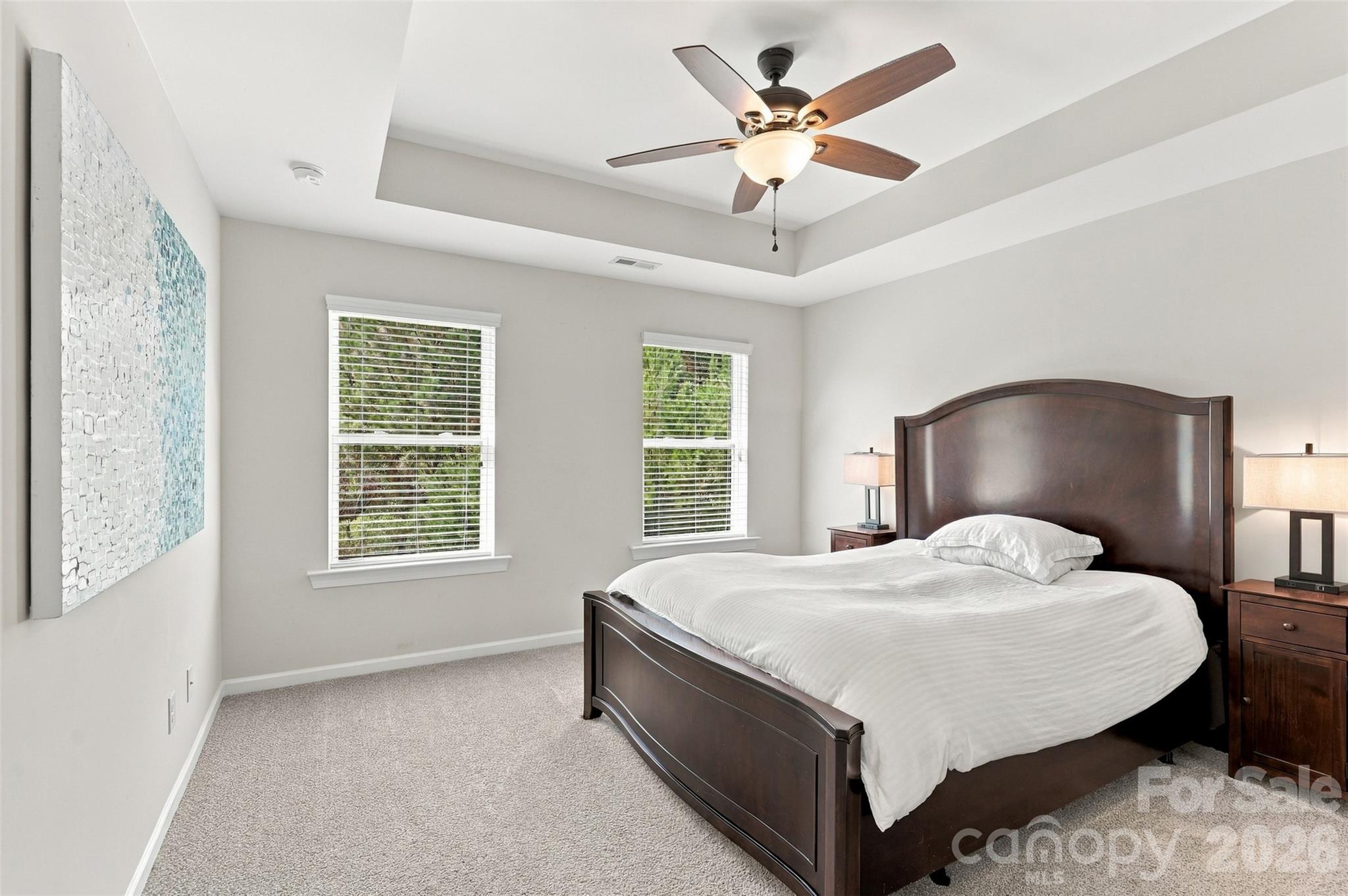 Bedroom 2- tray ceiling, ensuite bath with tiled floors, dual vanity, & tub/shower combo! - 1020 Archibald Avenue, Fort Mill