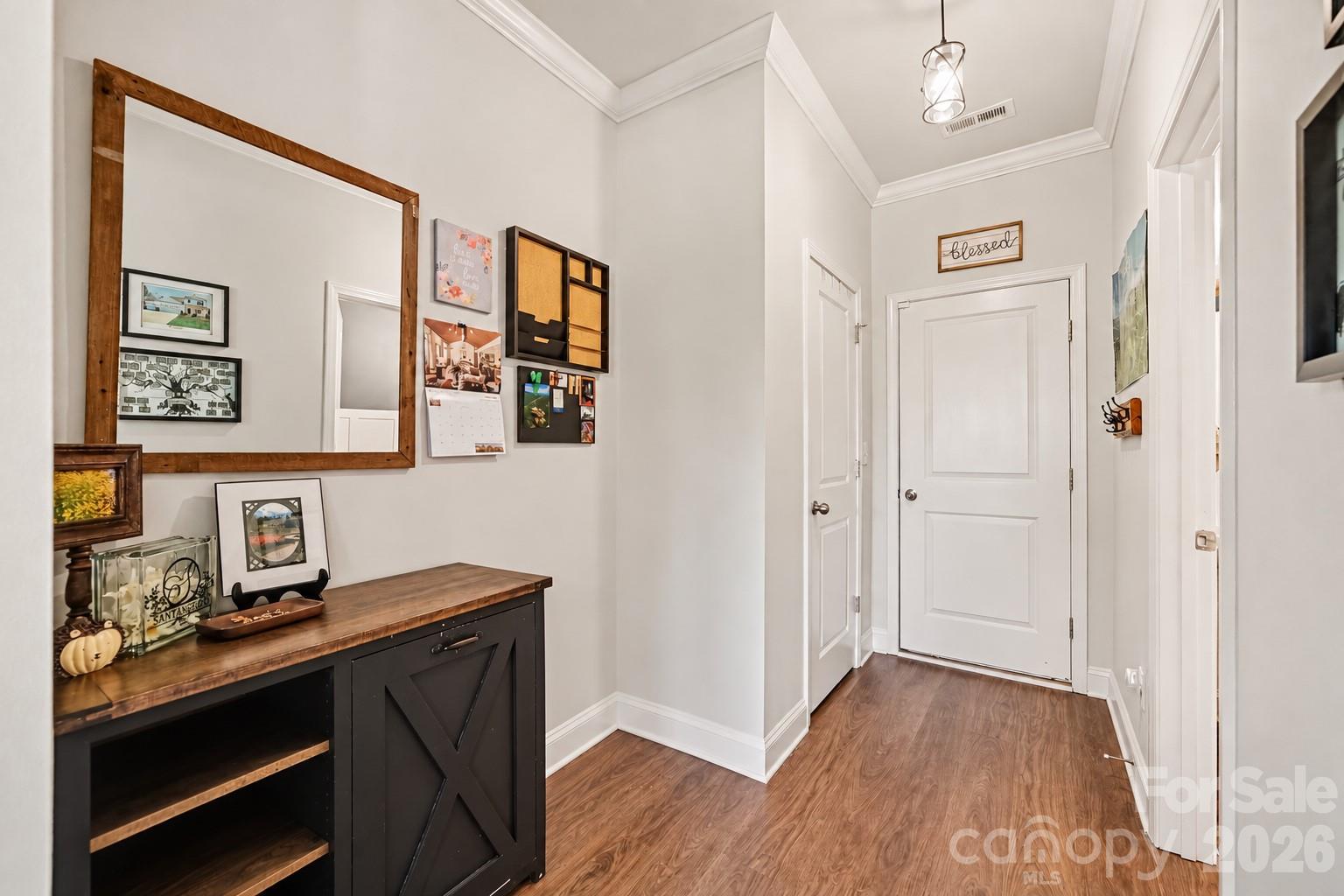 A wide hallway with space for a drop zone or console table. - 2703 Wedgewood Court, Denver