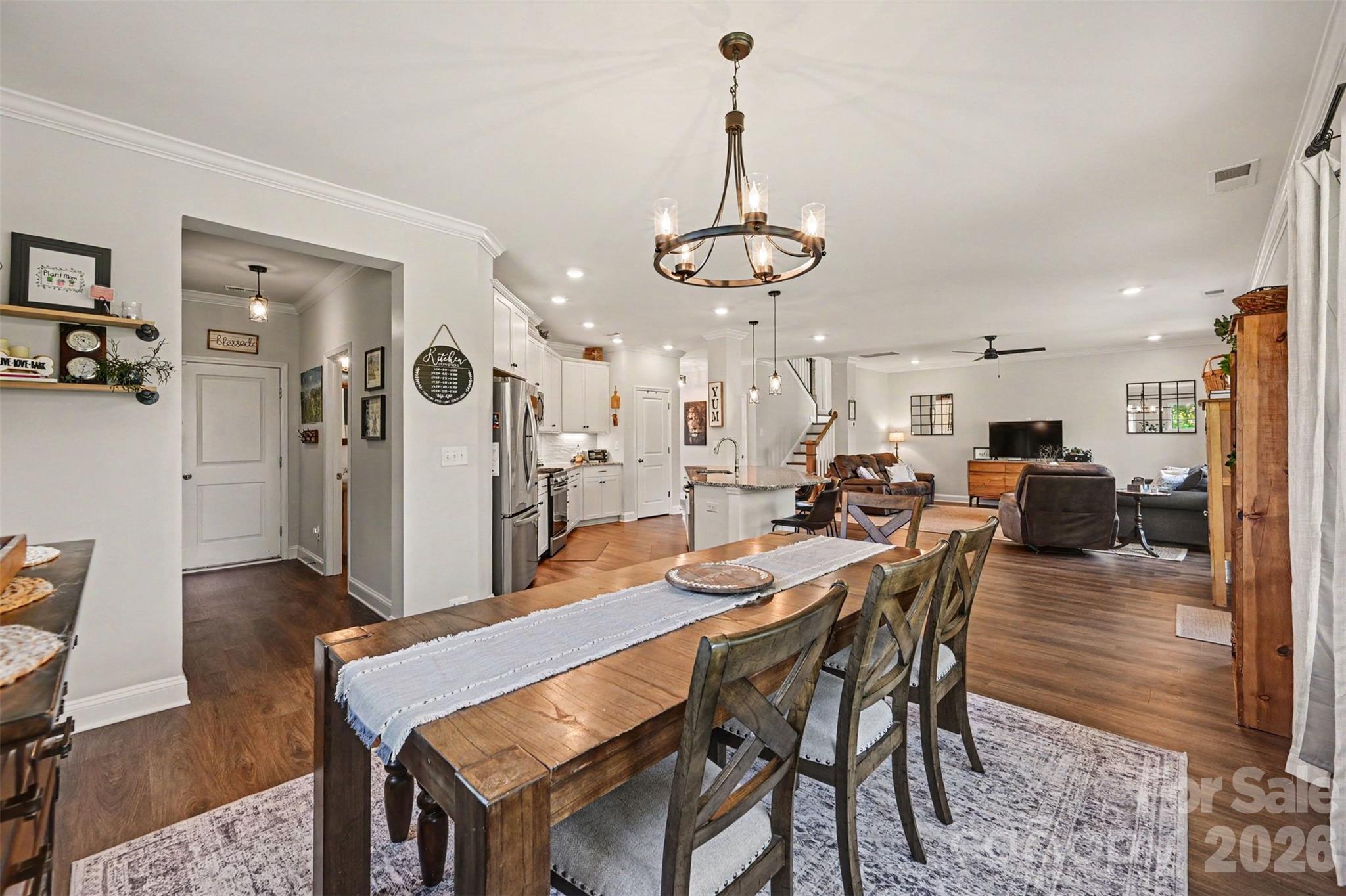 From the dining table you can see straight through the main level, so the conversation keeps going. - 2703 Wedgewood Court, Denver