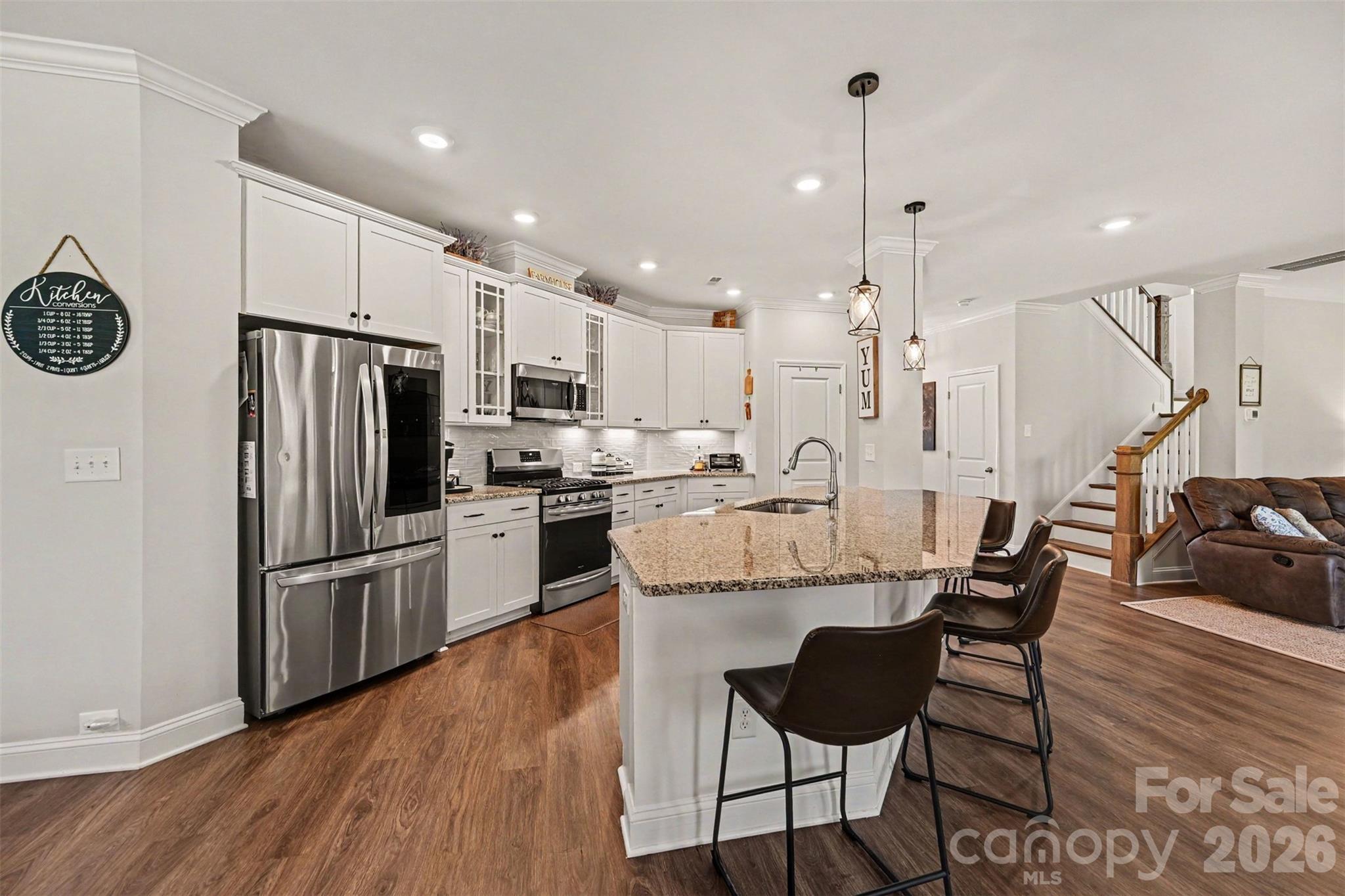 Stainless appliances and an island with bar seating, all open to the rest of the main level. - 2703 Wedgewood Court, Denver