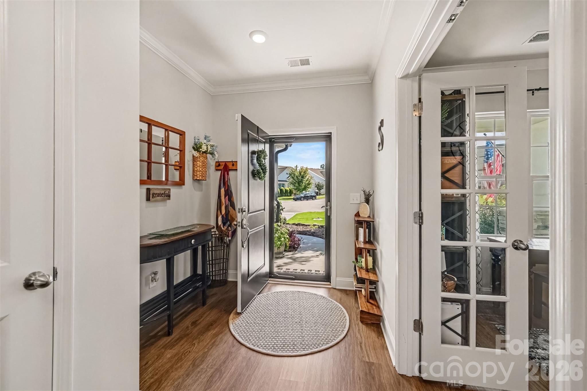 A welcoming foyer with glass French doors and a view straight out the front door. - 2703 Wedgewood Court, Denver