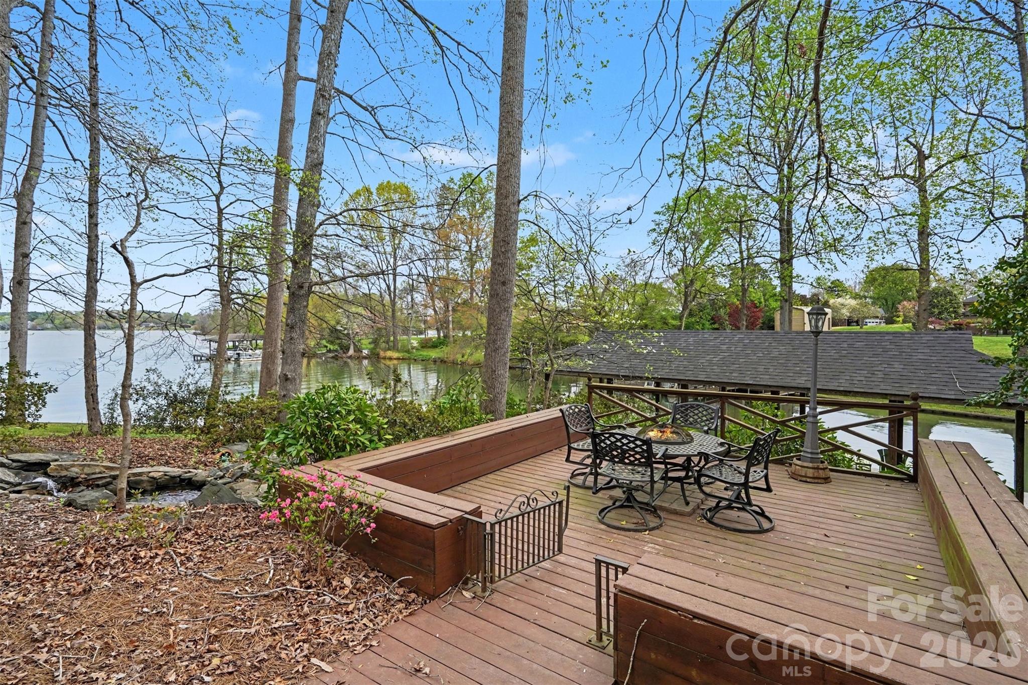 Separate deck with wrap-around bench seating and an artificial waterfall for enjoying long-range water views! - 185 Appian Way, Shelby