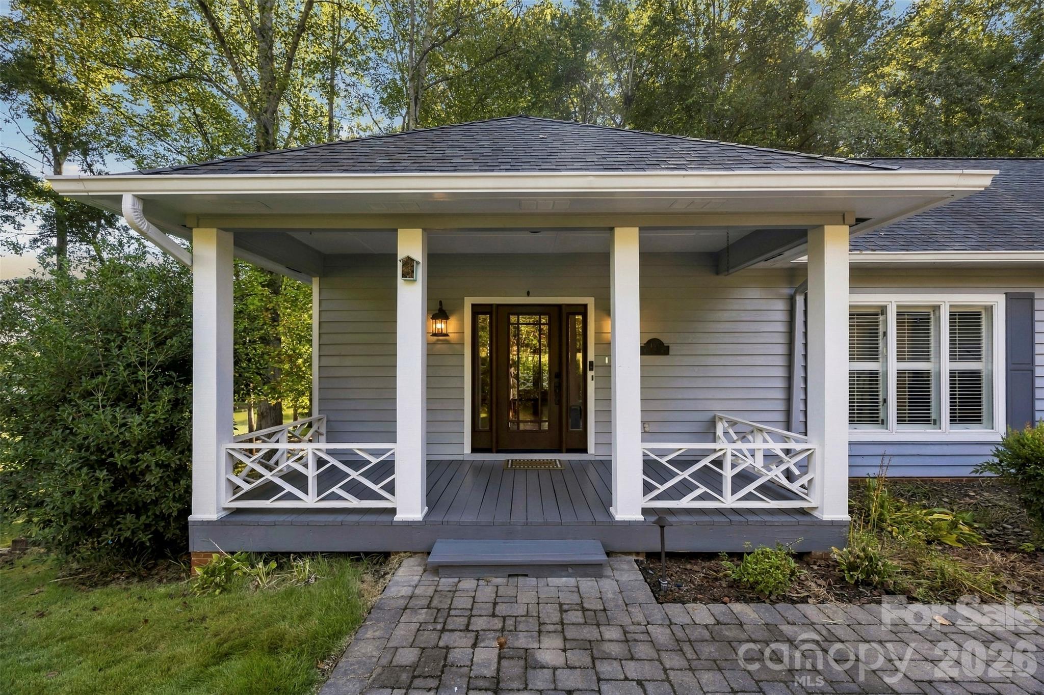 Freshly painted covered front porch with chippendale railing - 185 Appian Way, Shelby