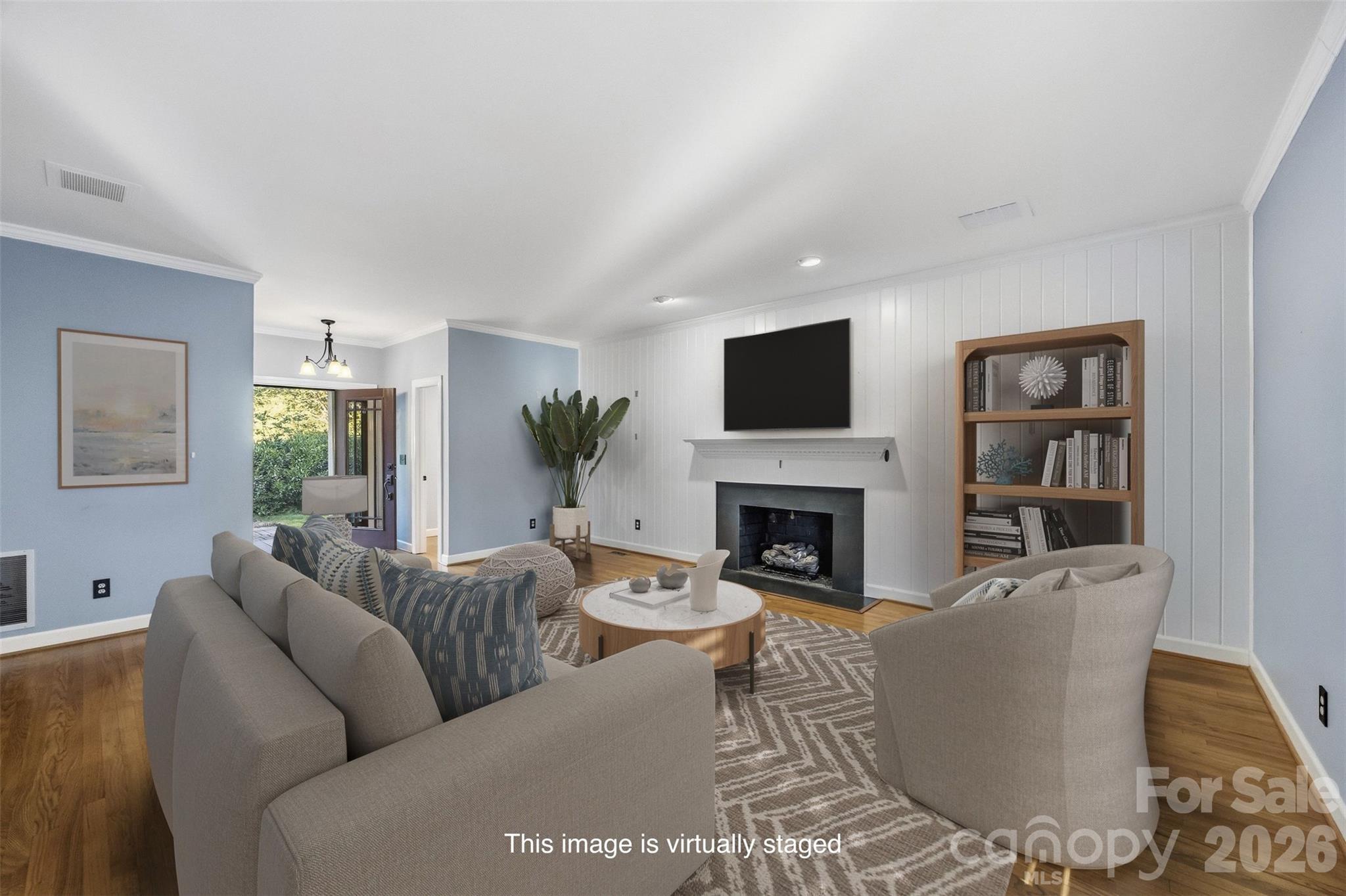 Welcome inside! Virtually staged living room w/ gas log fireplace and half bath near the front door. - 185 Appian Way, Shelby