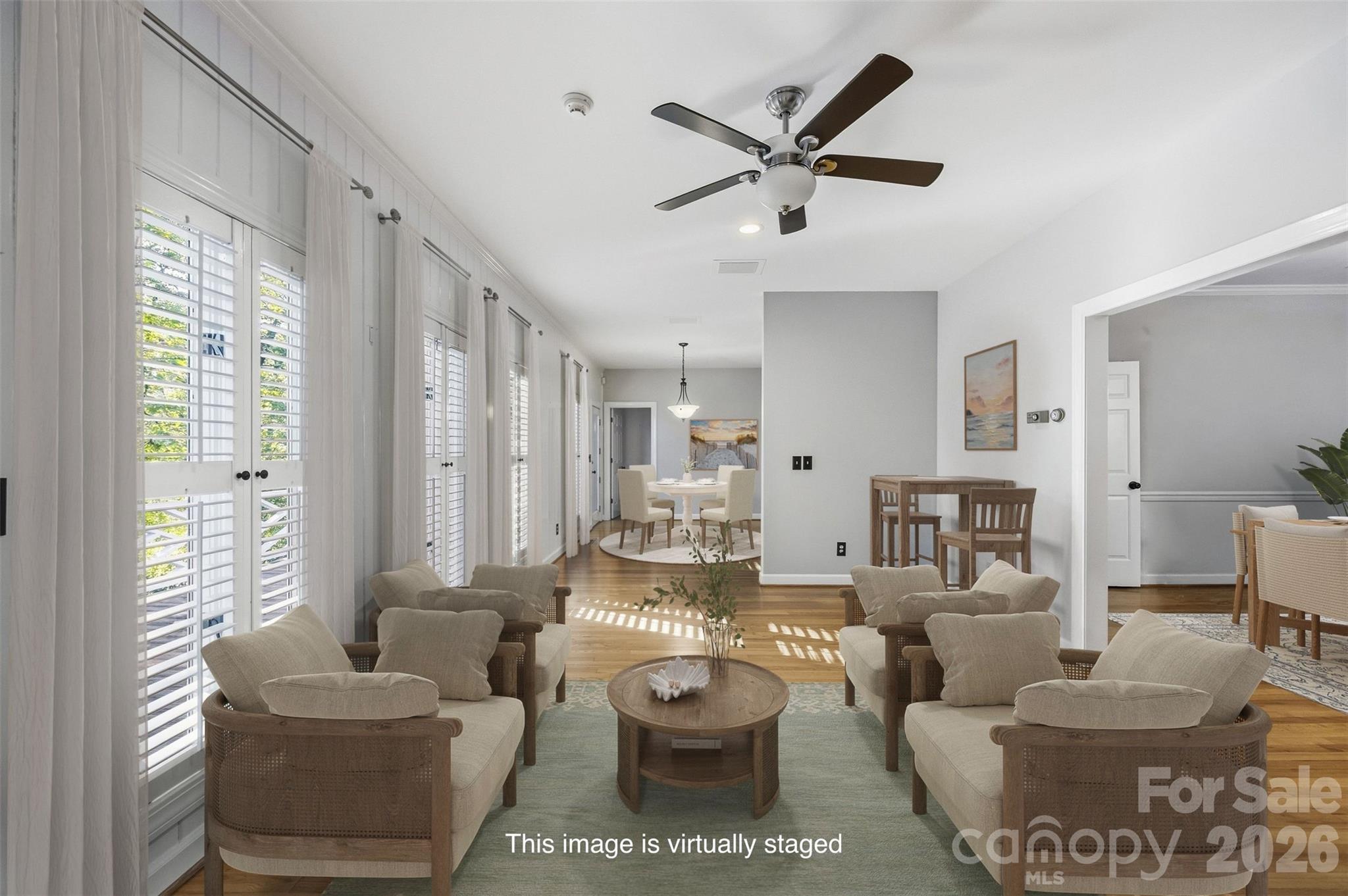 Virtually staged family room area has wet bar (not pictured) and connects to the living room, dining room, and breakfast room - 185 Appian Way, Shelby