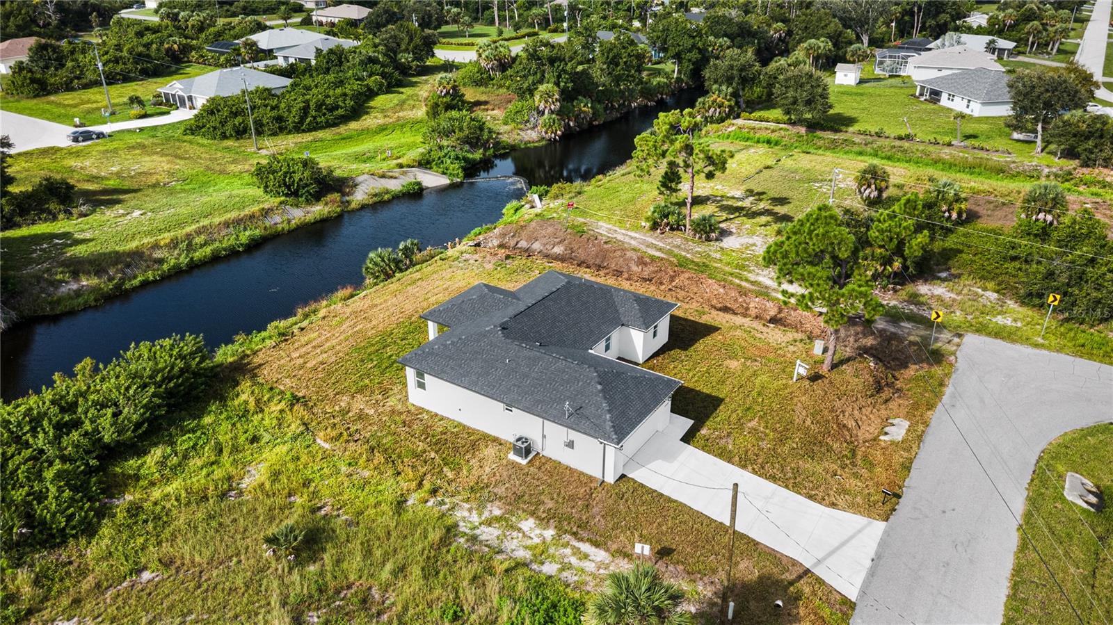 Non-navigable flowing water fishing canal. - 12025 CLARENDON AVE, PORT CHARLOTTE