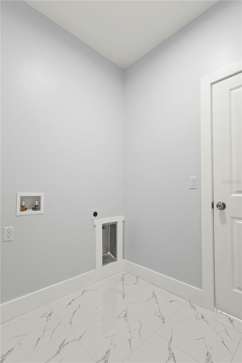 Laundry area in side of the house - 12025 CLARENDON AVE, PORT CHARLOTTE