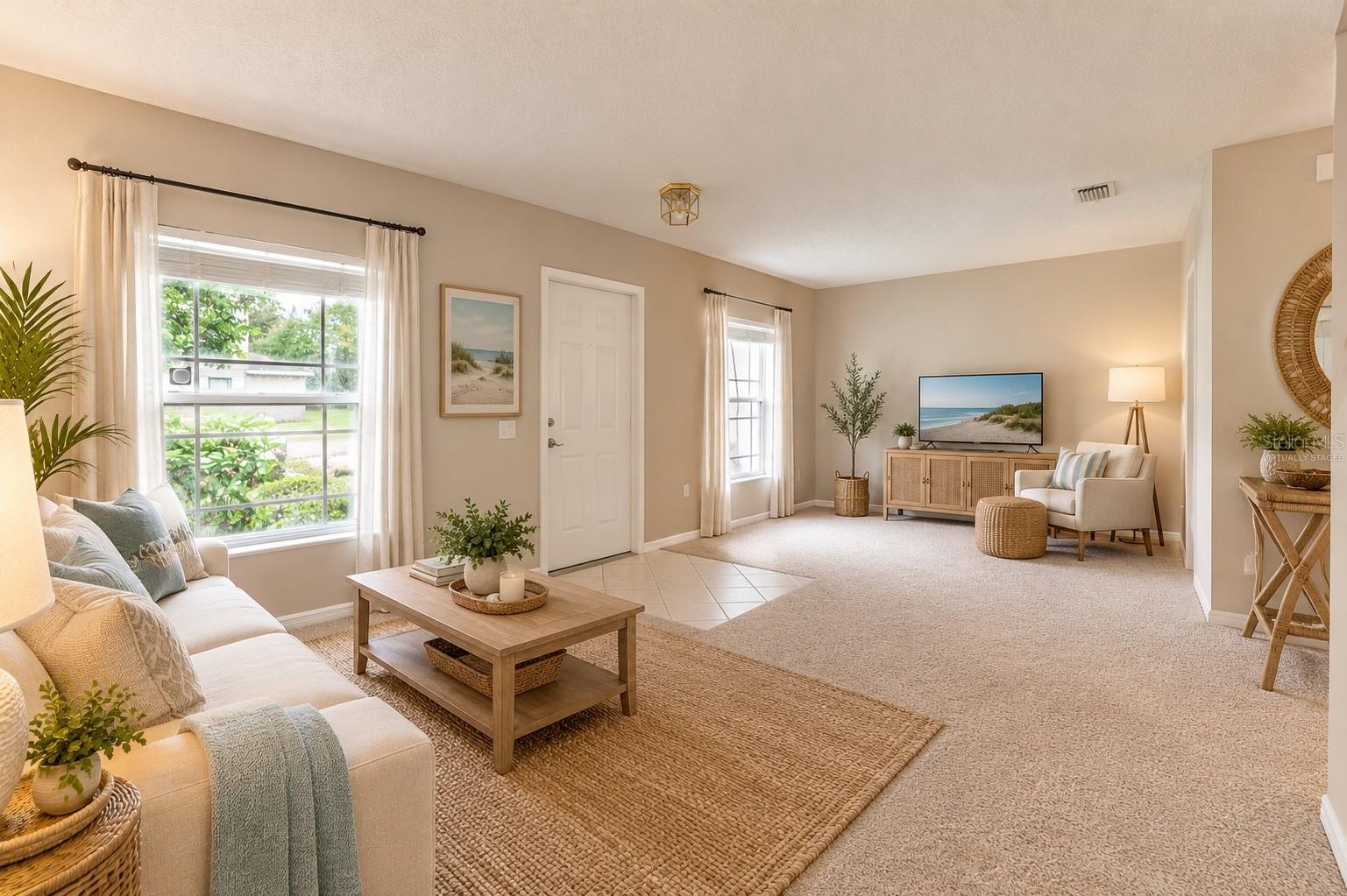 Virtually staged bright front living room. greeting you as you enter the home! - 14745 AMBERJACK TER #1, BRADENTON