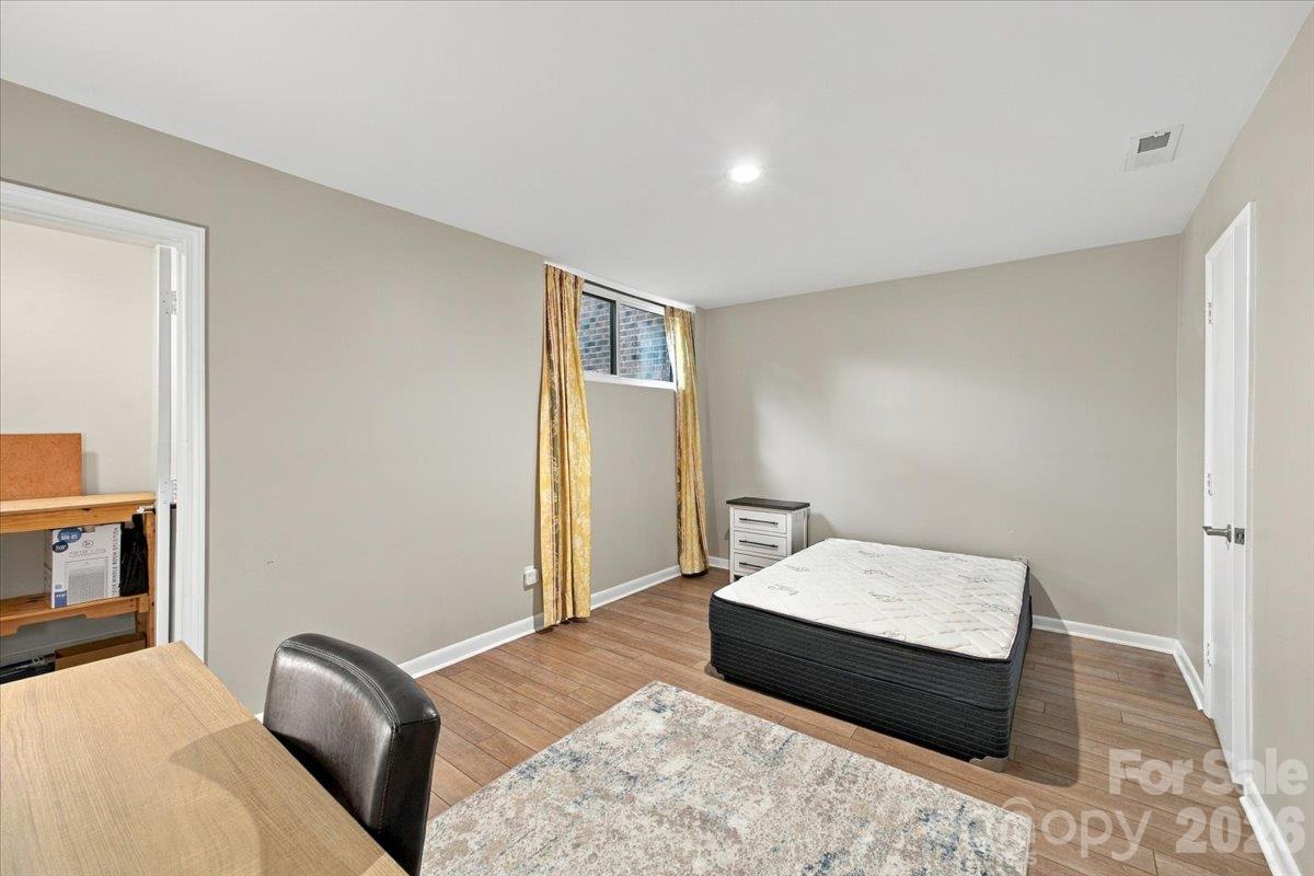 Basement level bedroom with ensuite and ample closet and storage space. - 5805 Sharon Road, Charlotte