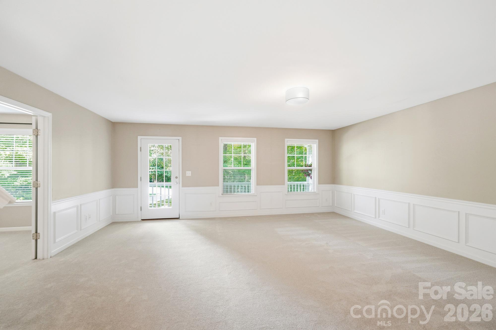 Loft area with chair rail molding and door to 2nd level porch - 5409 Cotton Top Court, Waxhaw