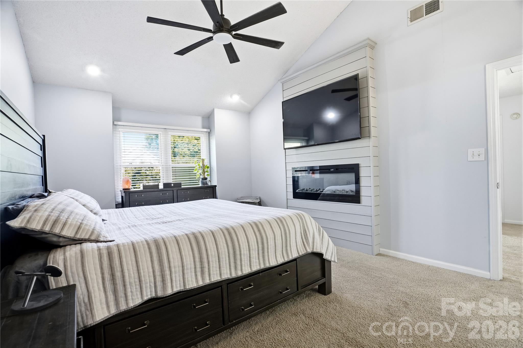 Fireplace accent wall in primary bedroom - 119 Shining Armor Court, Mooresville