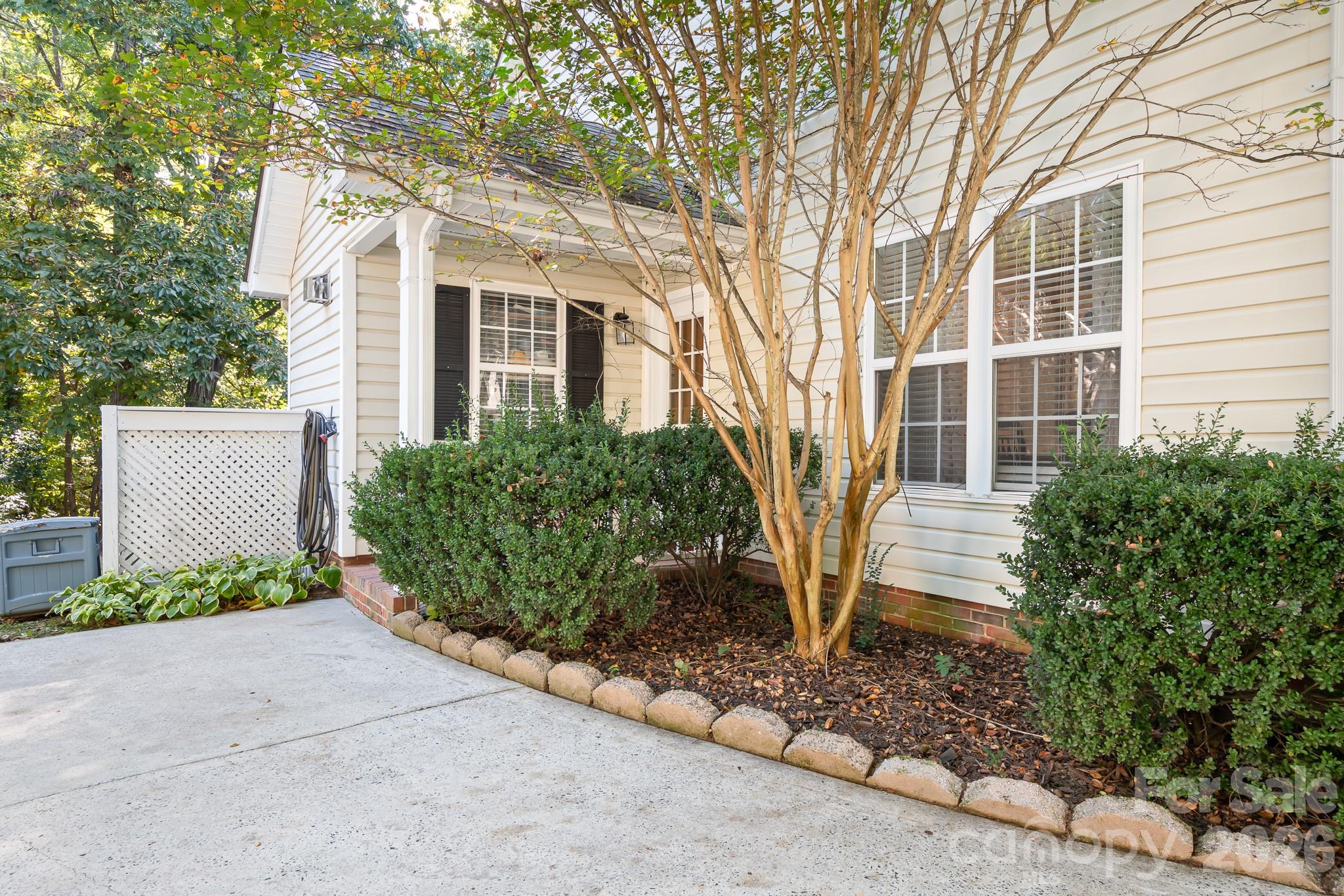 Large Driveway pad leads to covered walk way entering the laundry room.  Storage unit on the back of the house for all your tools and extra things! - 4126 Medford Drive NW, Concord