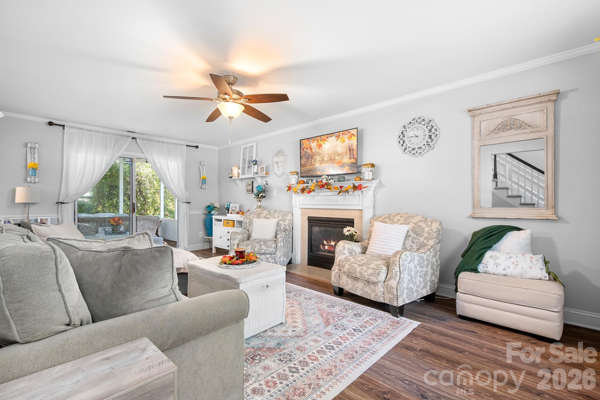 Large family room with gas fireplace and ceiling fan. back overlooks woods. - 4126 Medford Drive NW, Concord