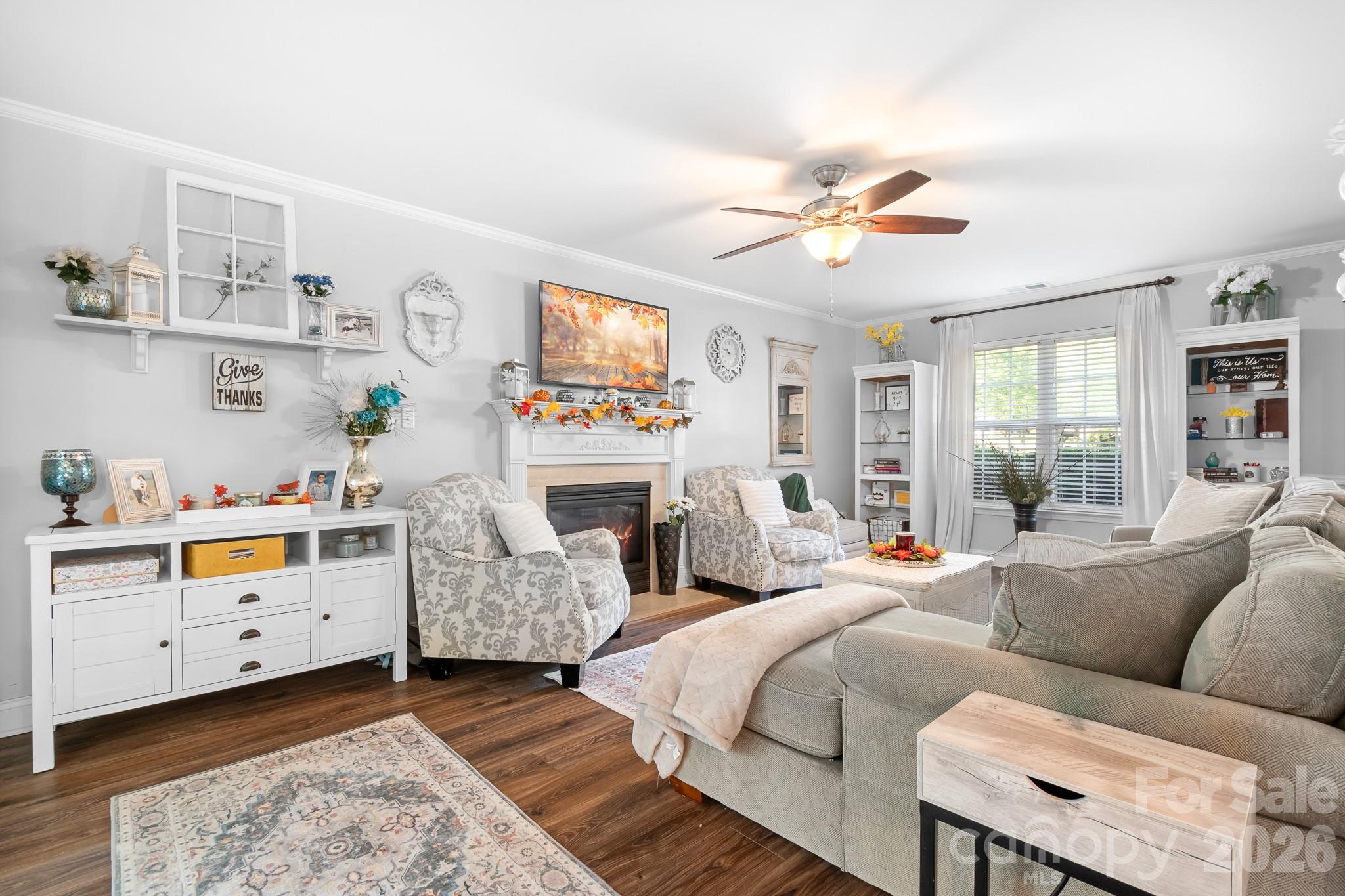 Spacious Family room with Gas Fireplace adn Ceiling Fan. Solid LVP flooring throughout main living areas. - 4126 Medford Drive NW, Concord