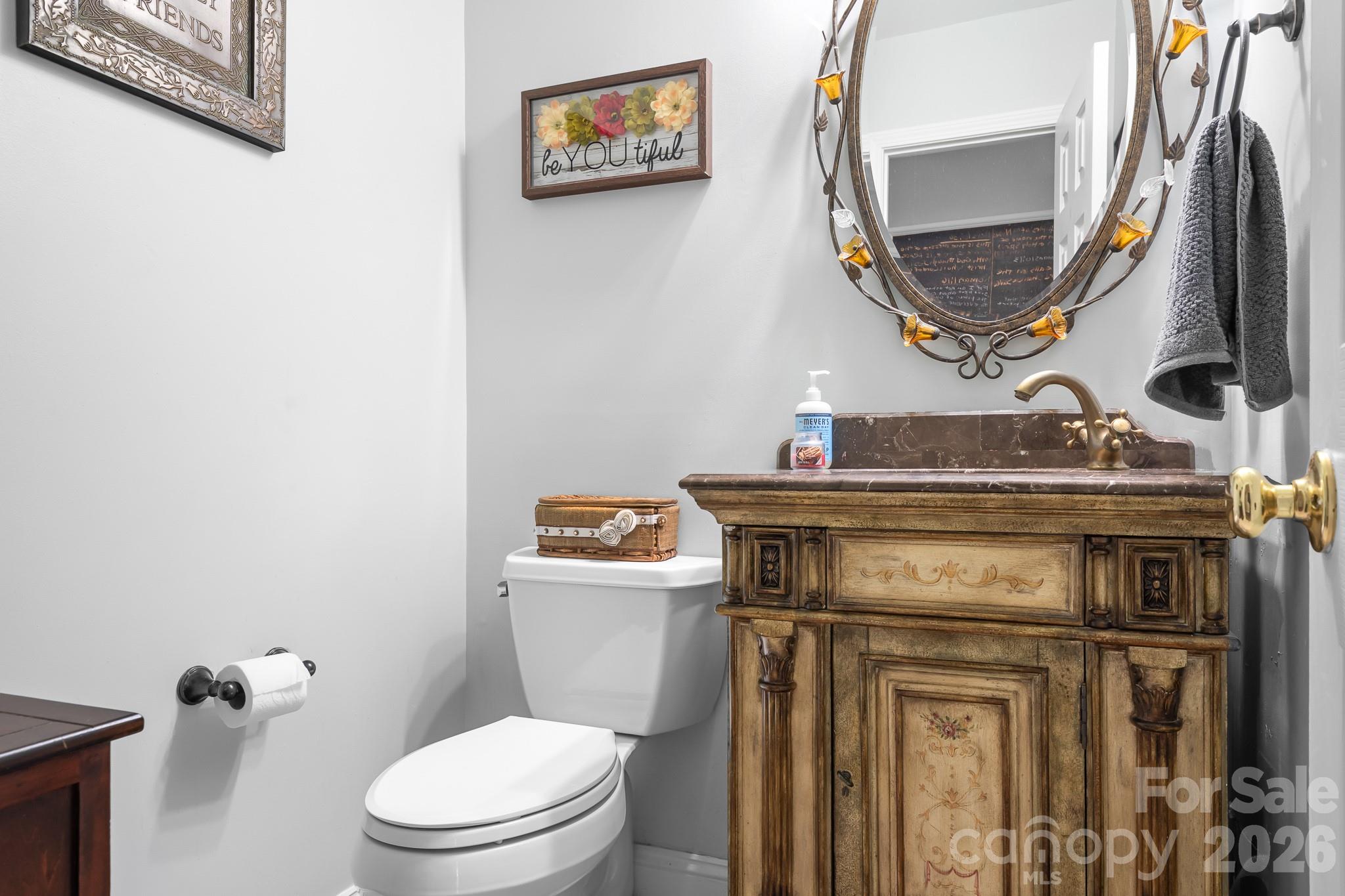 Powder Room on main level for your visiting guests.  Furniture style vanity and beautiful mirror for a custom warm look. - 4126 Medford Drive NW, Concord