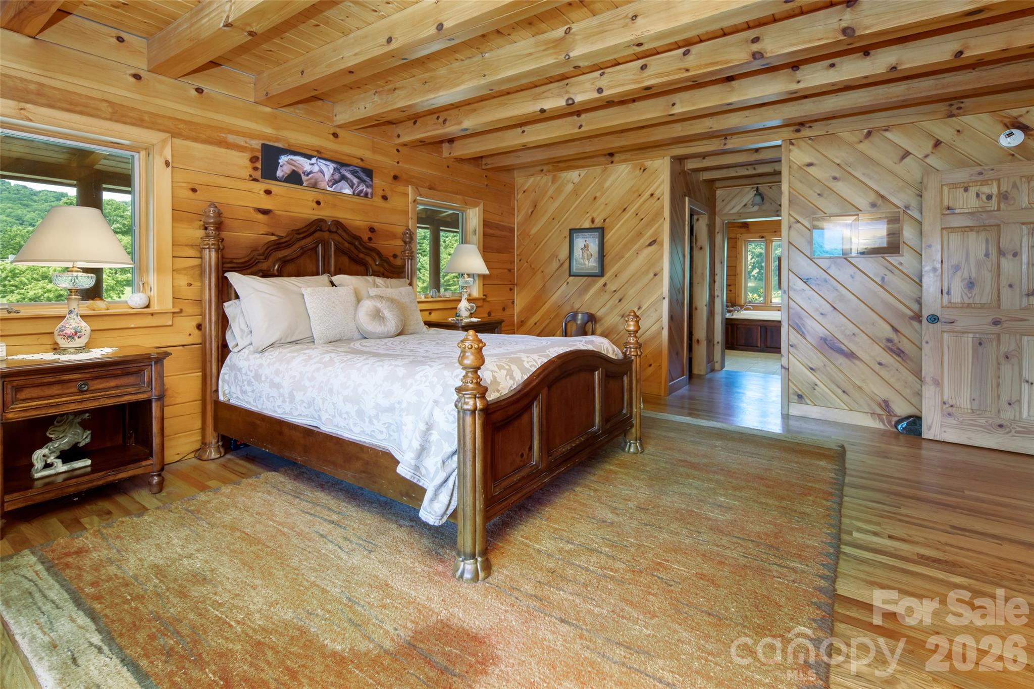 Primary bedroom on main level with en-suite full bathroom. - 316 Stevenson Cove Road, Waynesville