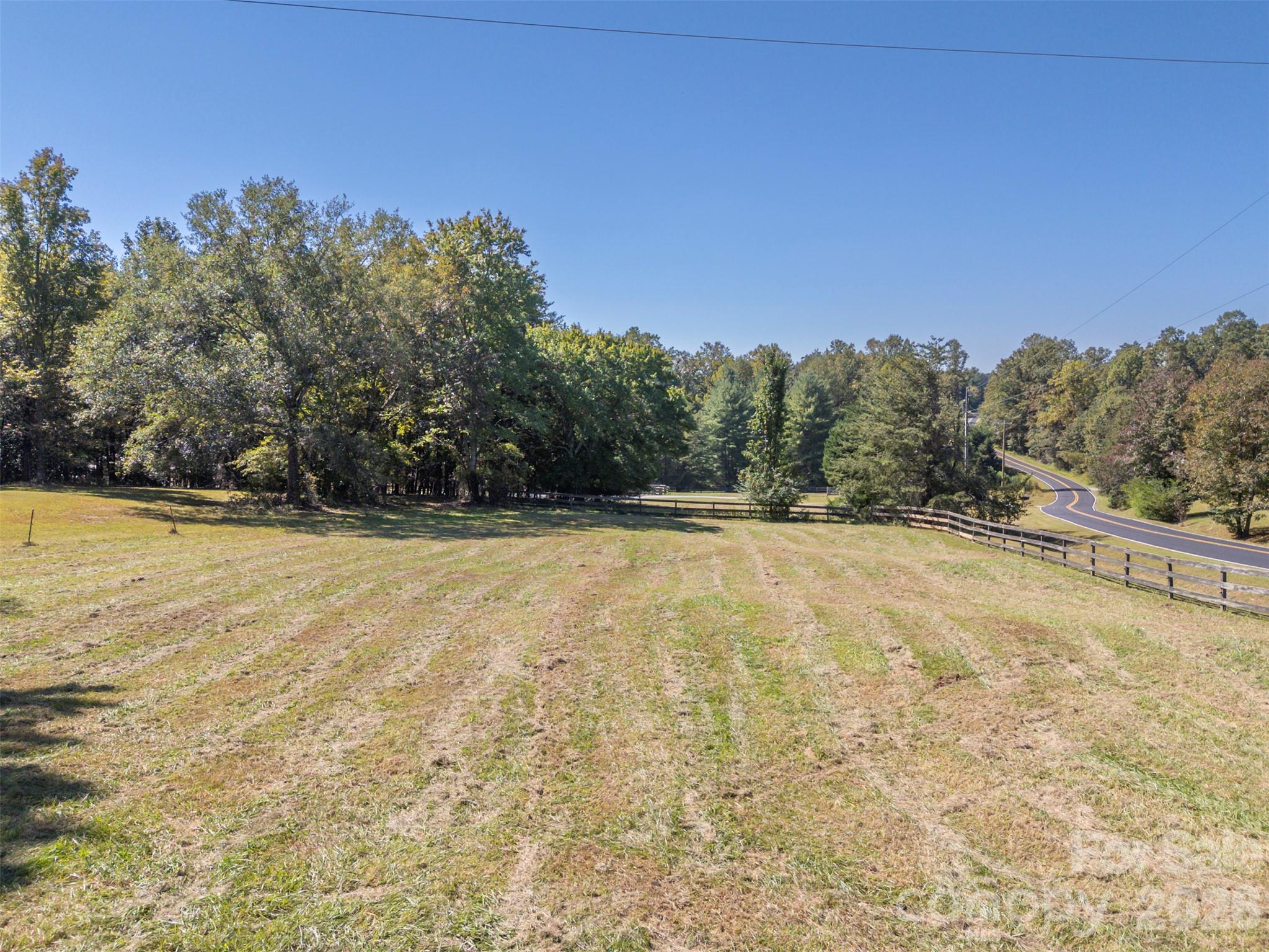 Pasture to right of driveway coming in. This is a circular driveway behind the trees but has not been used in years and tree has grown over driveway. - 600 John Weaver Road, Columbus