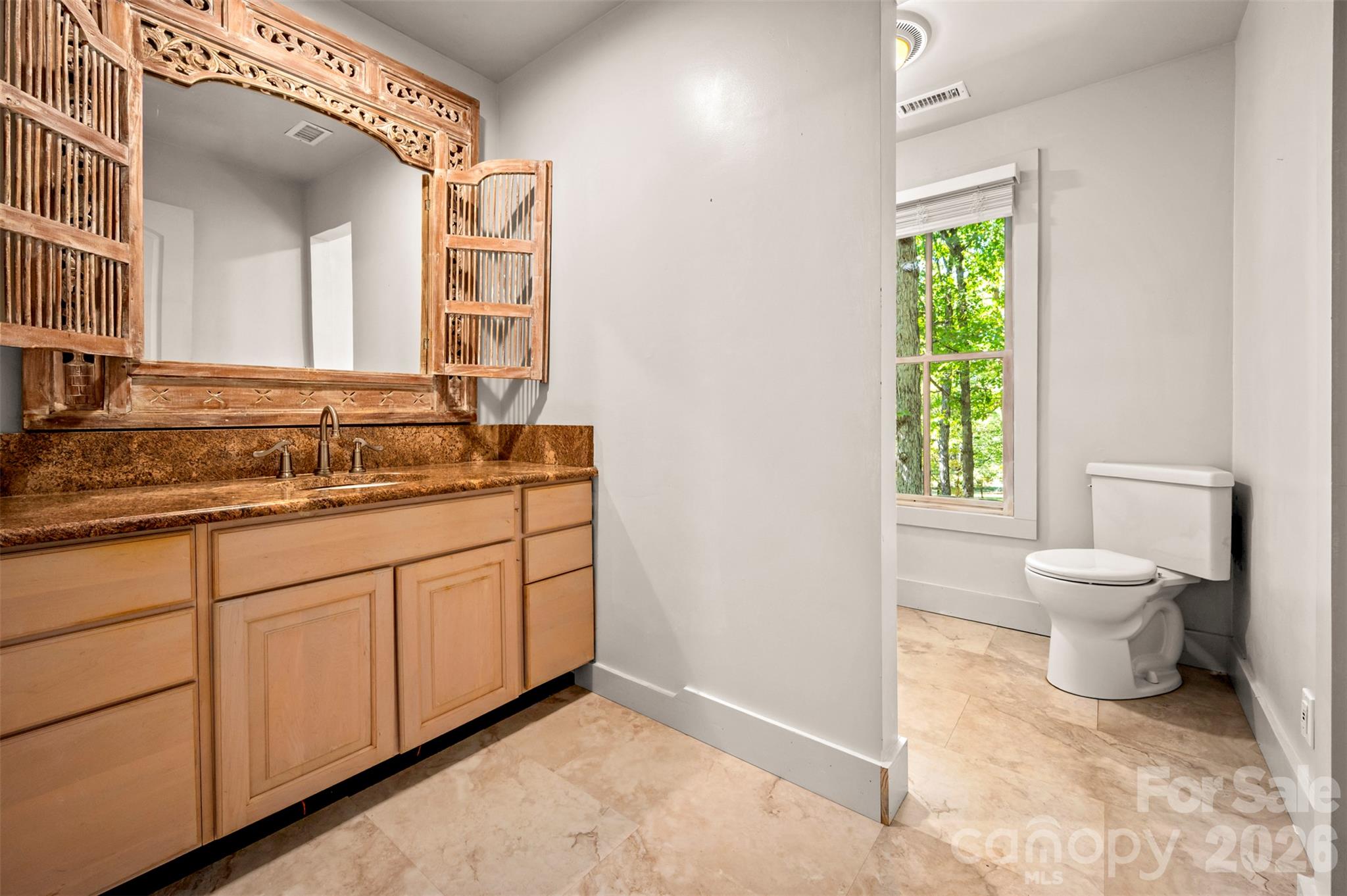 New hall bath with unique bathroom mirror and granite counters. - 600 John Weaver Road, Columbus