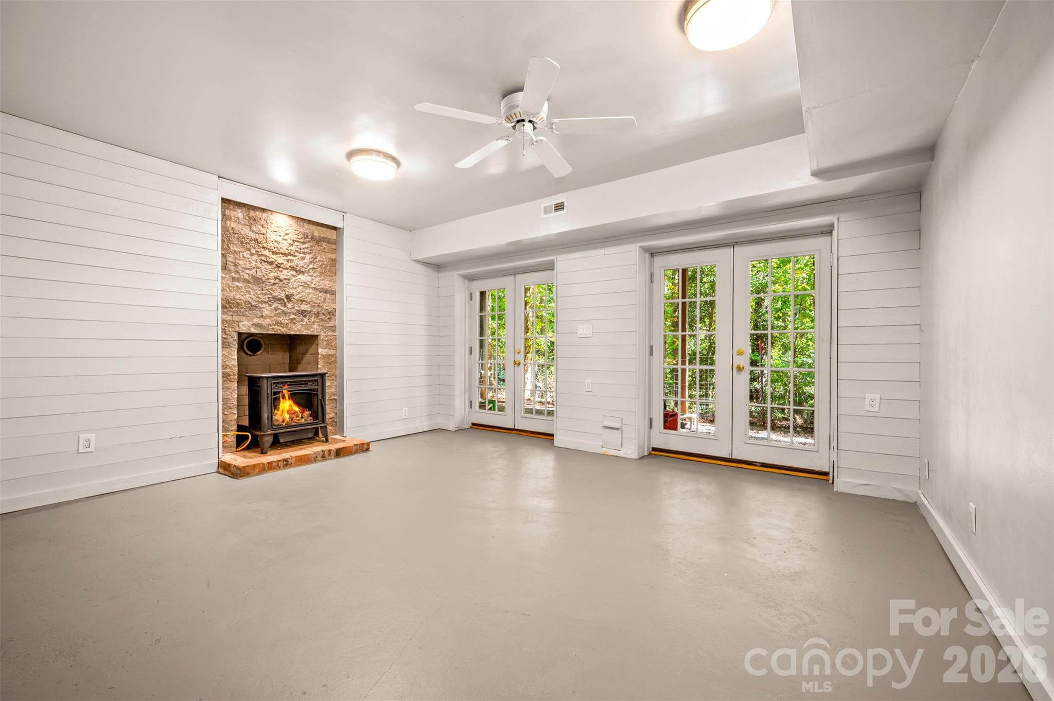 Basement Family room with unvented gas wood stove (vented for wood burning stove) PAINTED CONCRETE FLOORS - 600 John Weaver Road, Columbus
