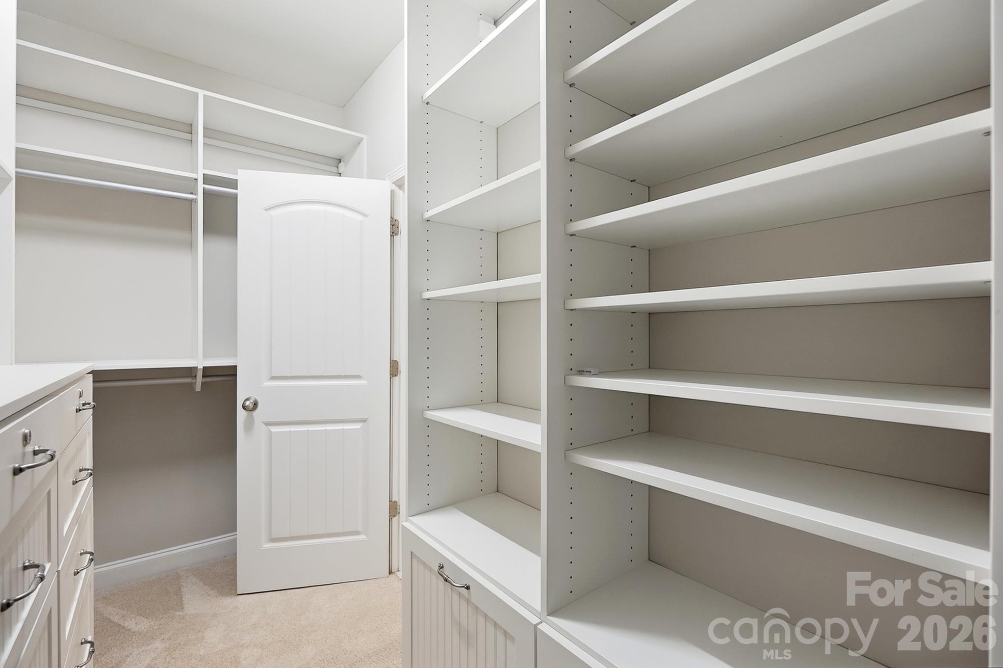 Custom walk-in closet with shelving, cabinetry, and 2 safes - 9106 Longvale Lane, Charlotte