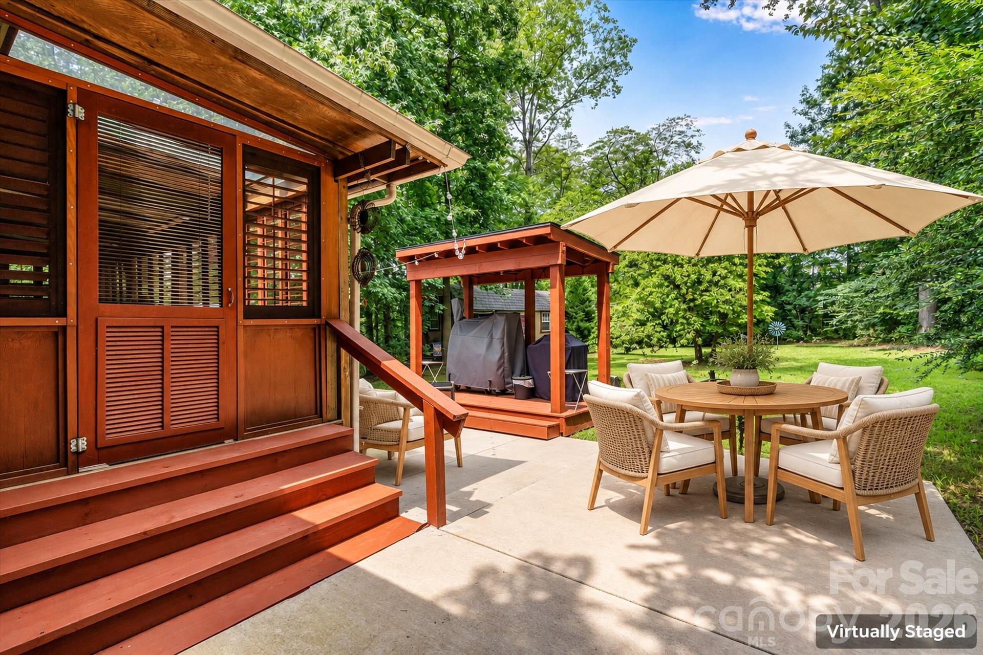 Backyard patio with grill canopy. Virtually Staged 7697 Katherine Drive - 7697 Katherine Drive, Denver