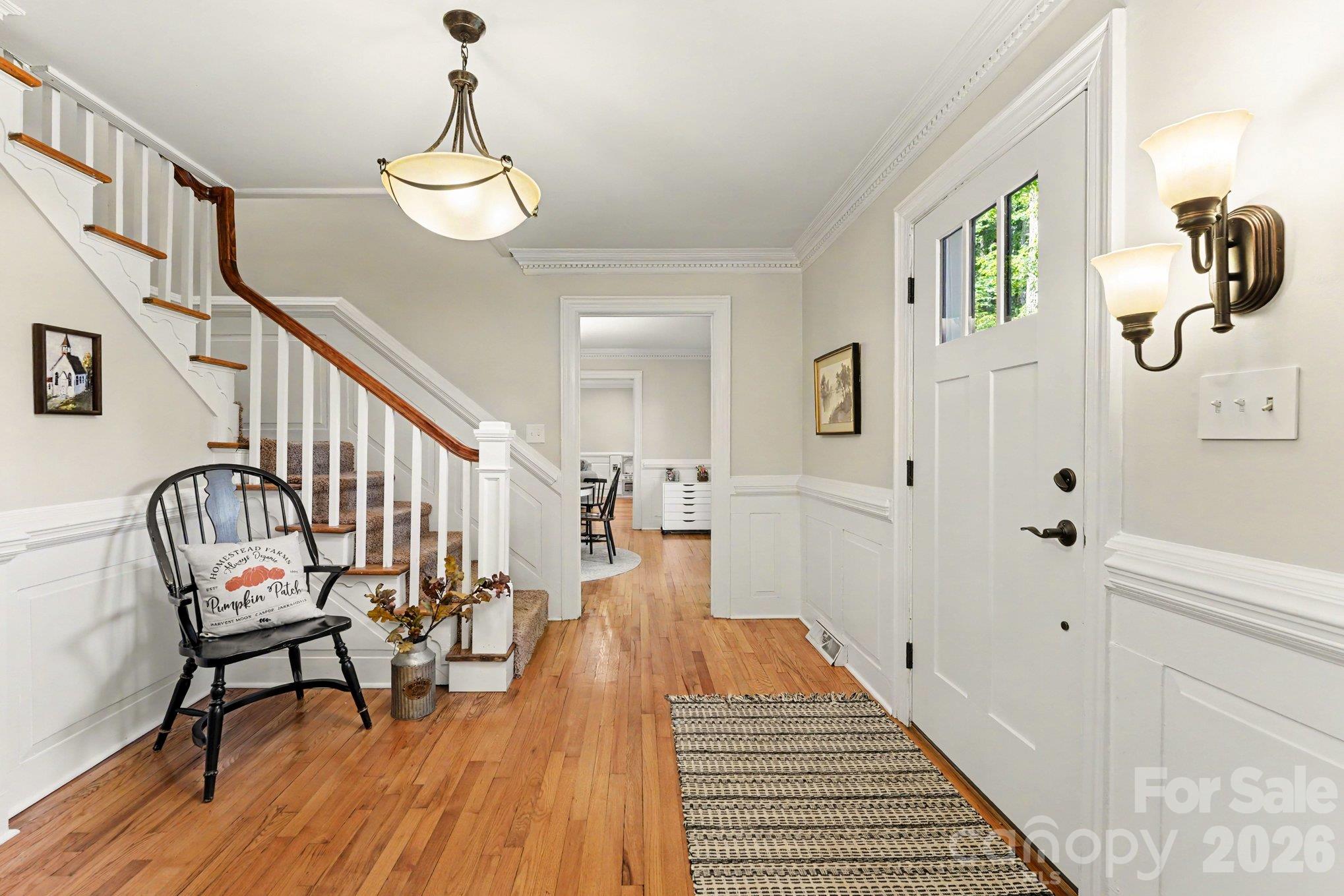 An inviting foyer with warm wood floors, elegant moldings, and a classic staircase sets the tone for this beautiful home - 607 Anderson Avenue, Salisbury
