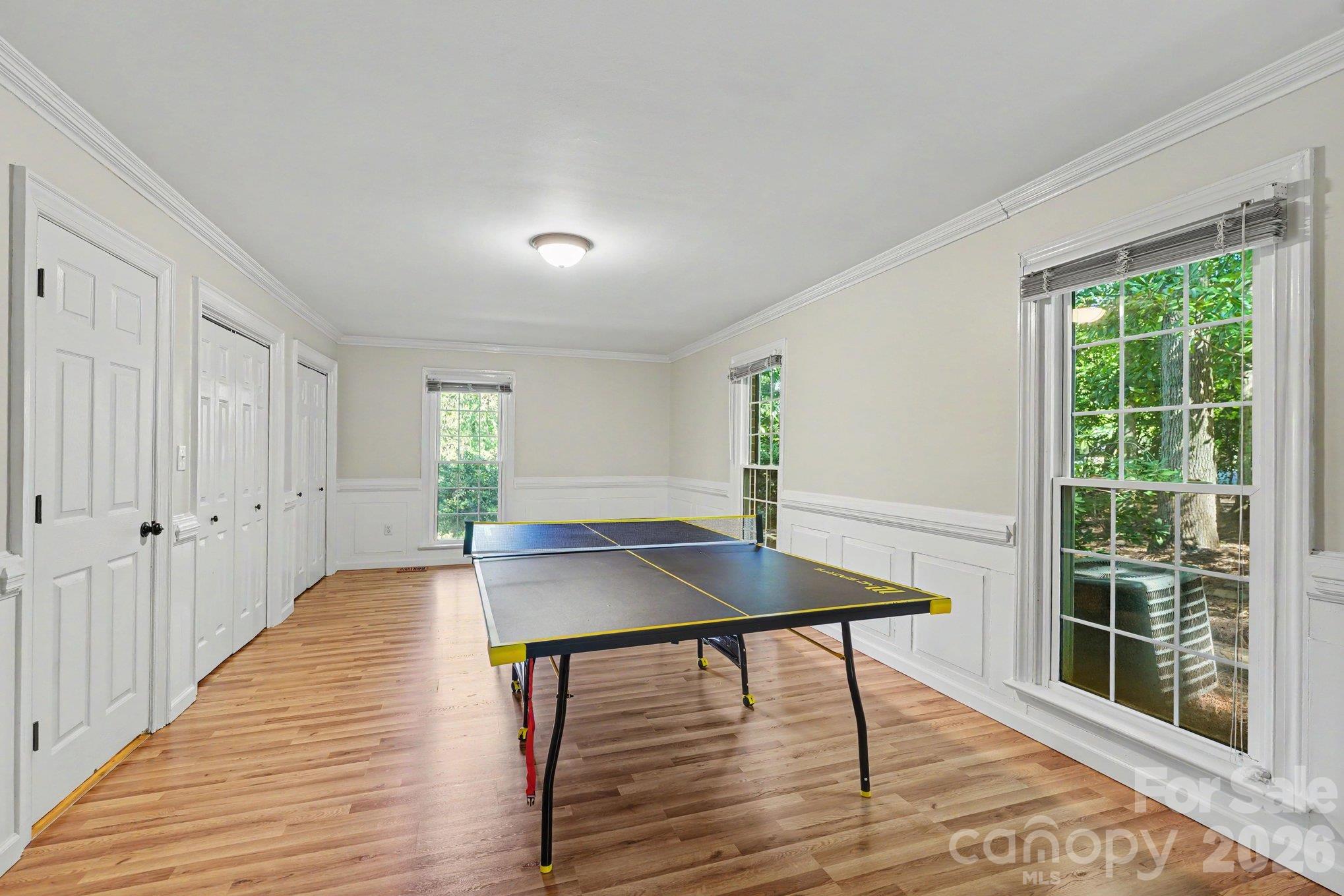 Generously sized main level primary bedroom with an en-suite bathroom, currently enjoyed as a game room. - 607 Anderson Avenue, Salisbury