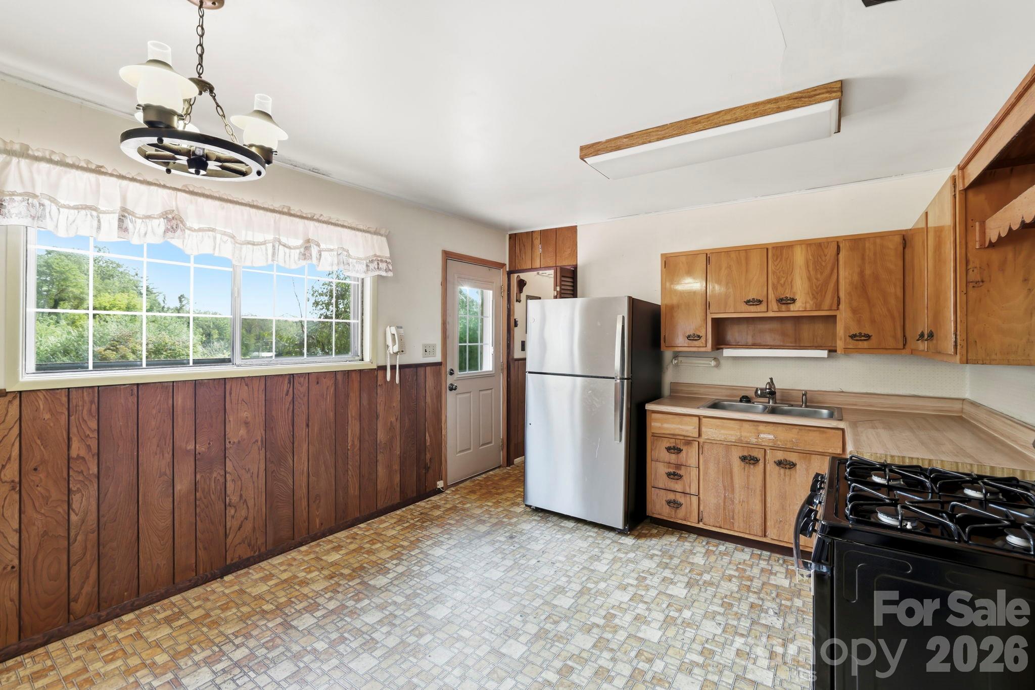 Kitchen, looking towards Living Room.  Door on left is to the back deck.  Door straight ahead is to the walk in pantry - 648 Crystal Drive - 648 Crystal Drive, Hendersonville