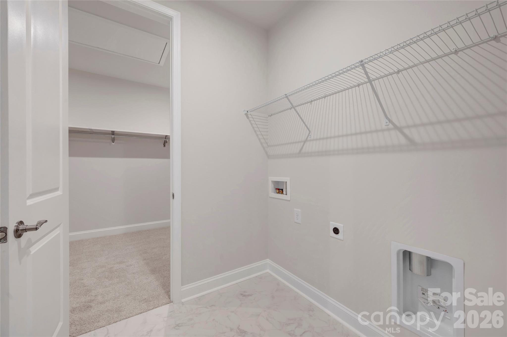 Laundry room with connection door into the primary walk-in closet - 201 Landy Street, Fort Mill