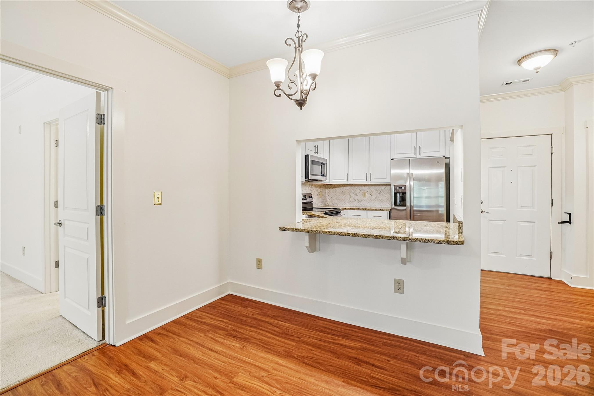 Dining area can fit a small table or add some barstools to the pass-through breakfast bar. - 9 Kenilworth Knolls, Asheville