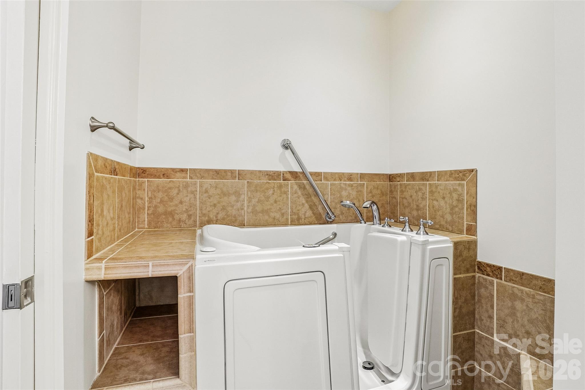 Pamper yourself in your private home spa, featuring a premium Liberation by American Standard therapeutic tub with heated hydro-massage jets and custom tile surround. - 9 Kenilworth Knolls, Asheville