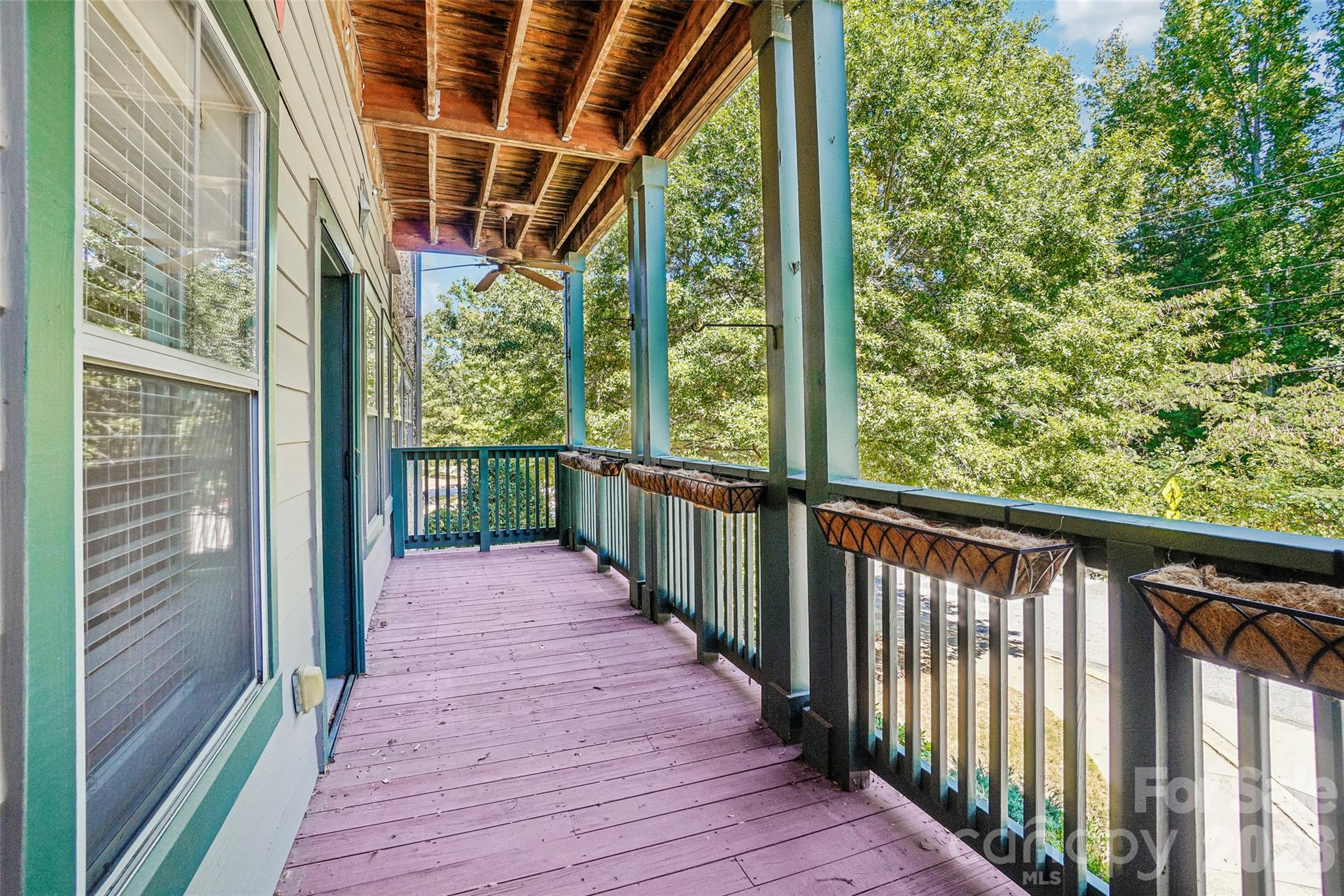 Covered balcony has plant boxes and hooks for hanging plants. - 9 Kenilworth Knolls, Asheville