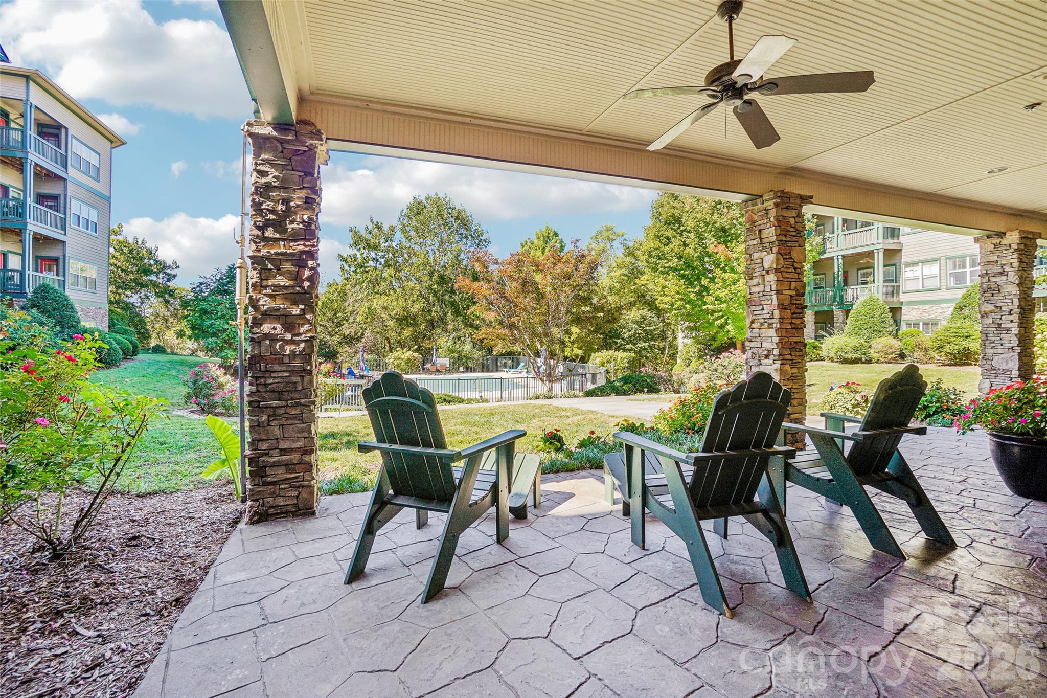 Another view of the common back patio area looking northwest towards the pool. - 9 Kenilworth Knolls, Asheville