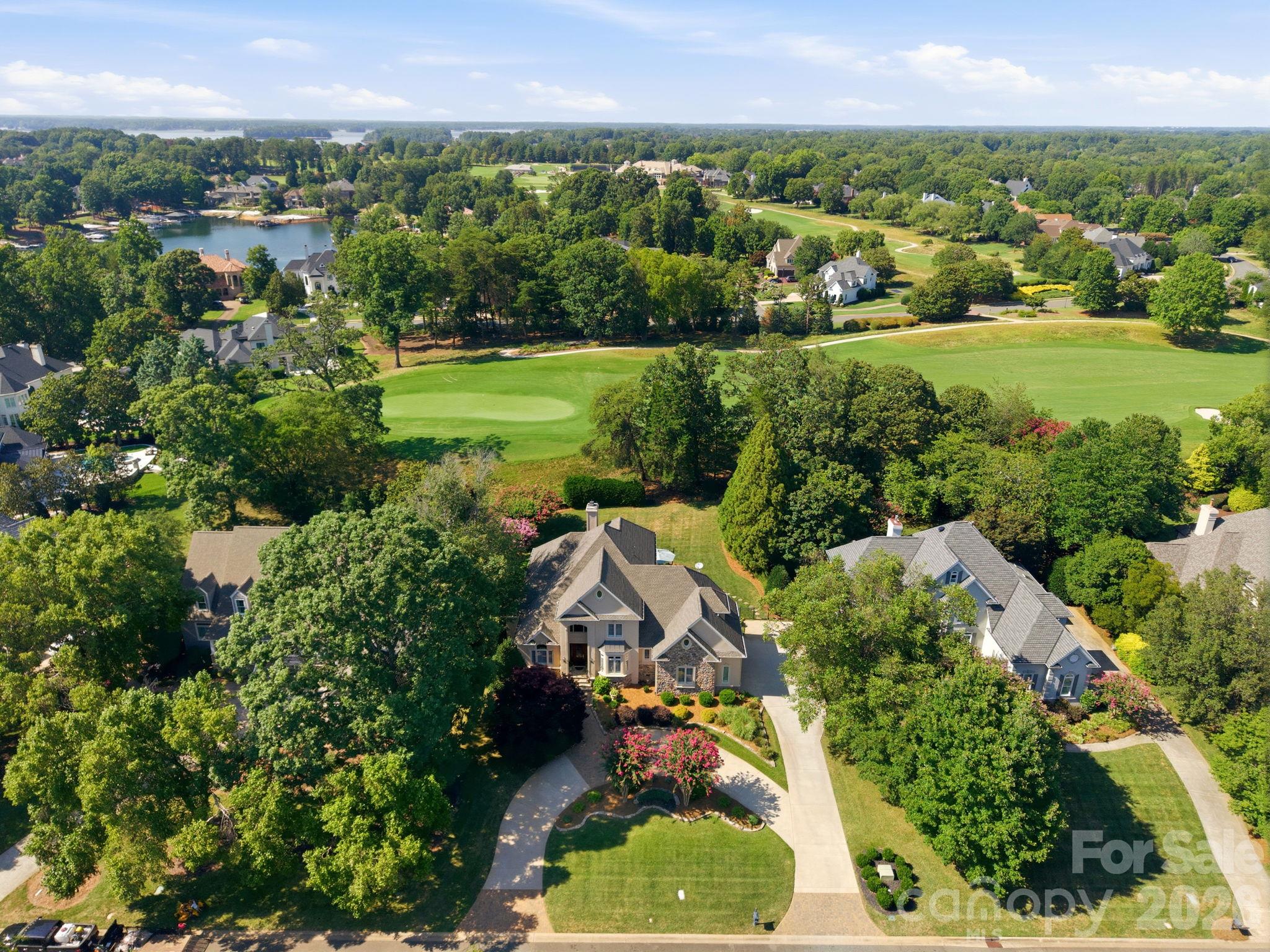Take in the bird's-eye view of your expansive property and lush, tree-lined surroundings. - 18416 Peninsula Club Drive, Cornelius