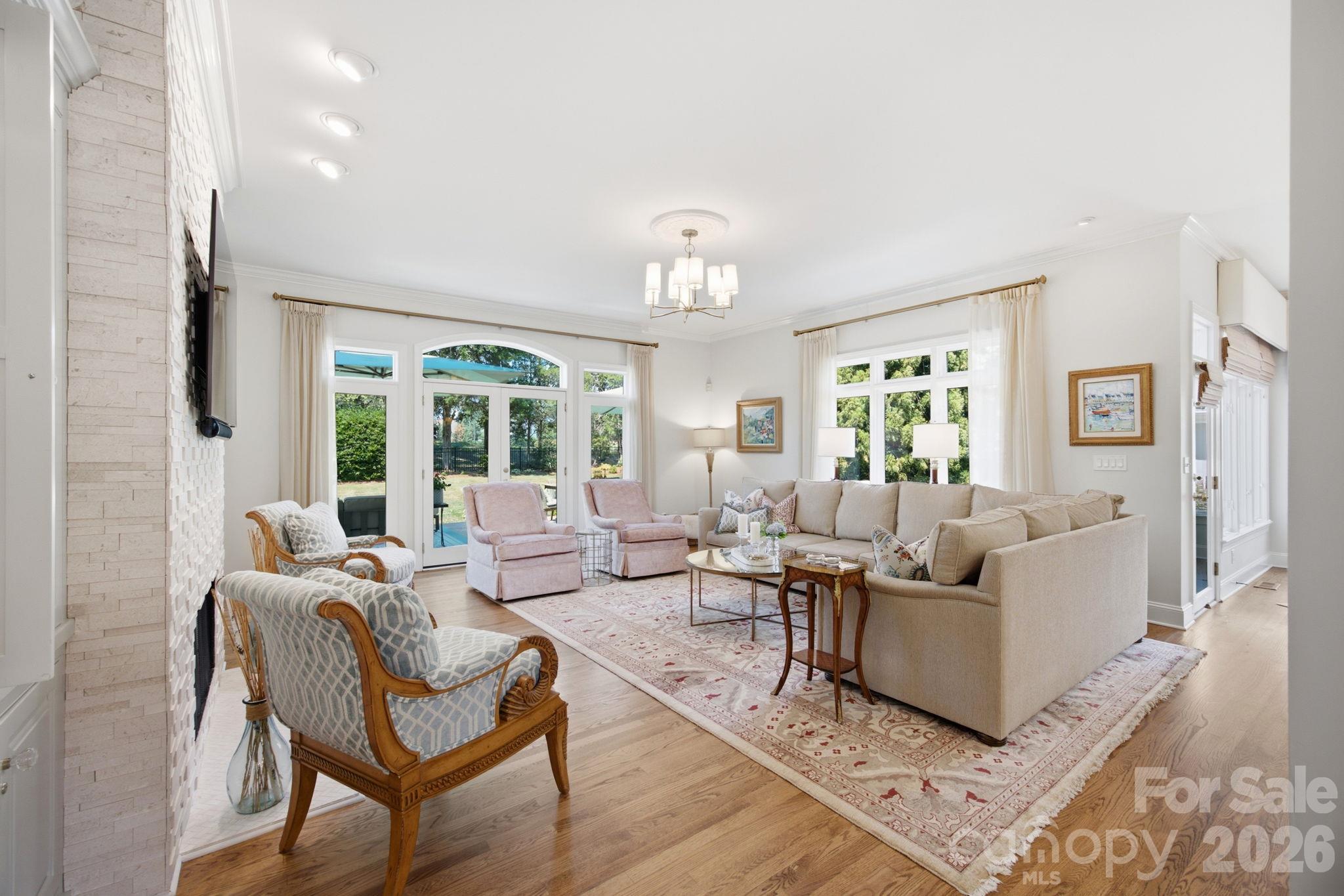 A bright, welcoming main-level living room designed for comfort and everyday relaxation. - 18416 Peninsula Club Drive, Cornelius