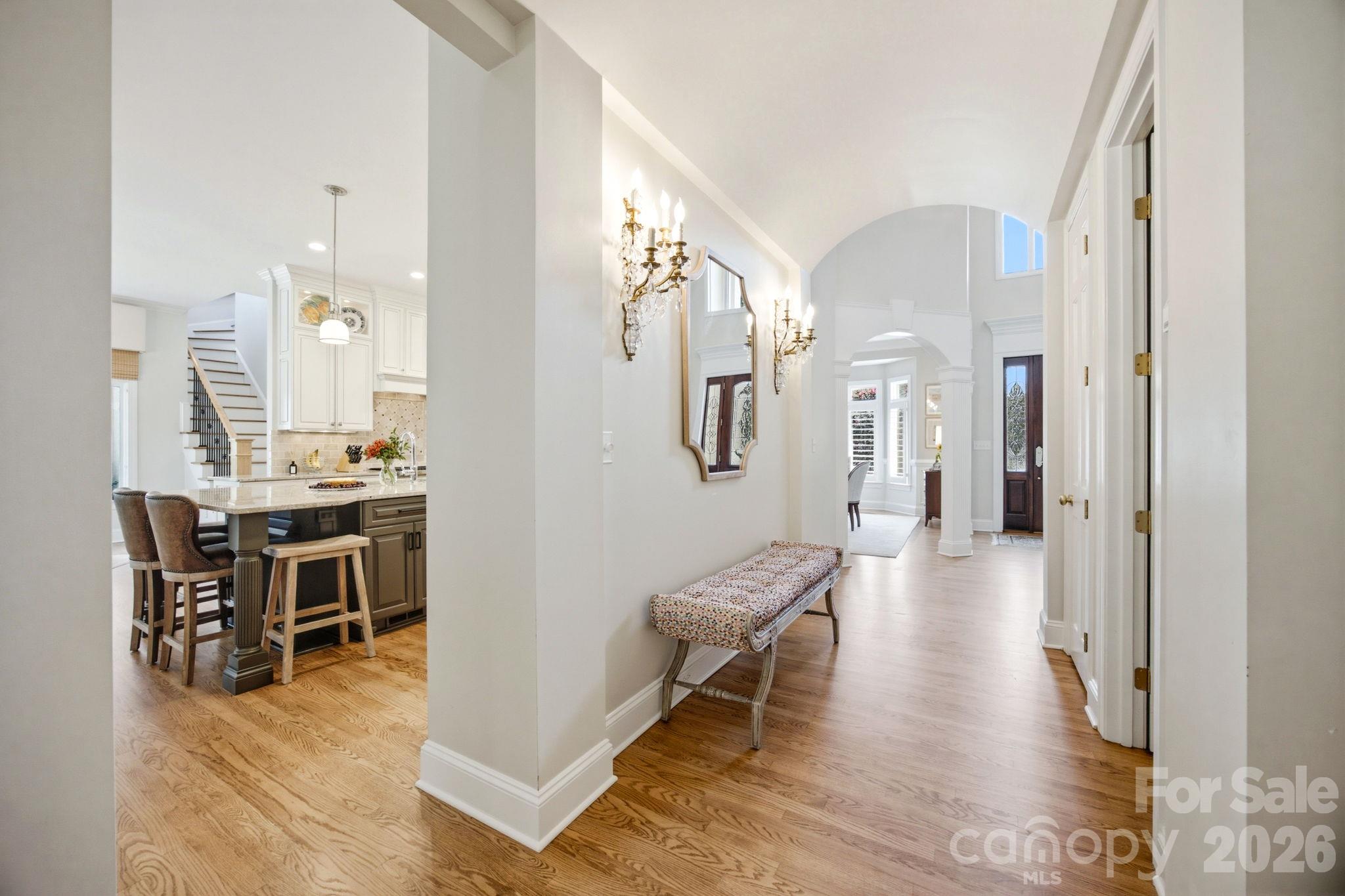 A graceful transitional hallway connecting the home's vibrant spaces. - 18416 Peninsula Club Drive, Cornelius