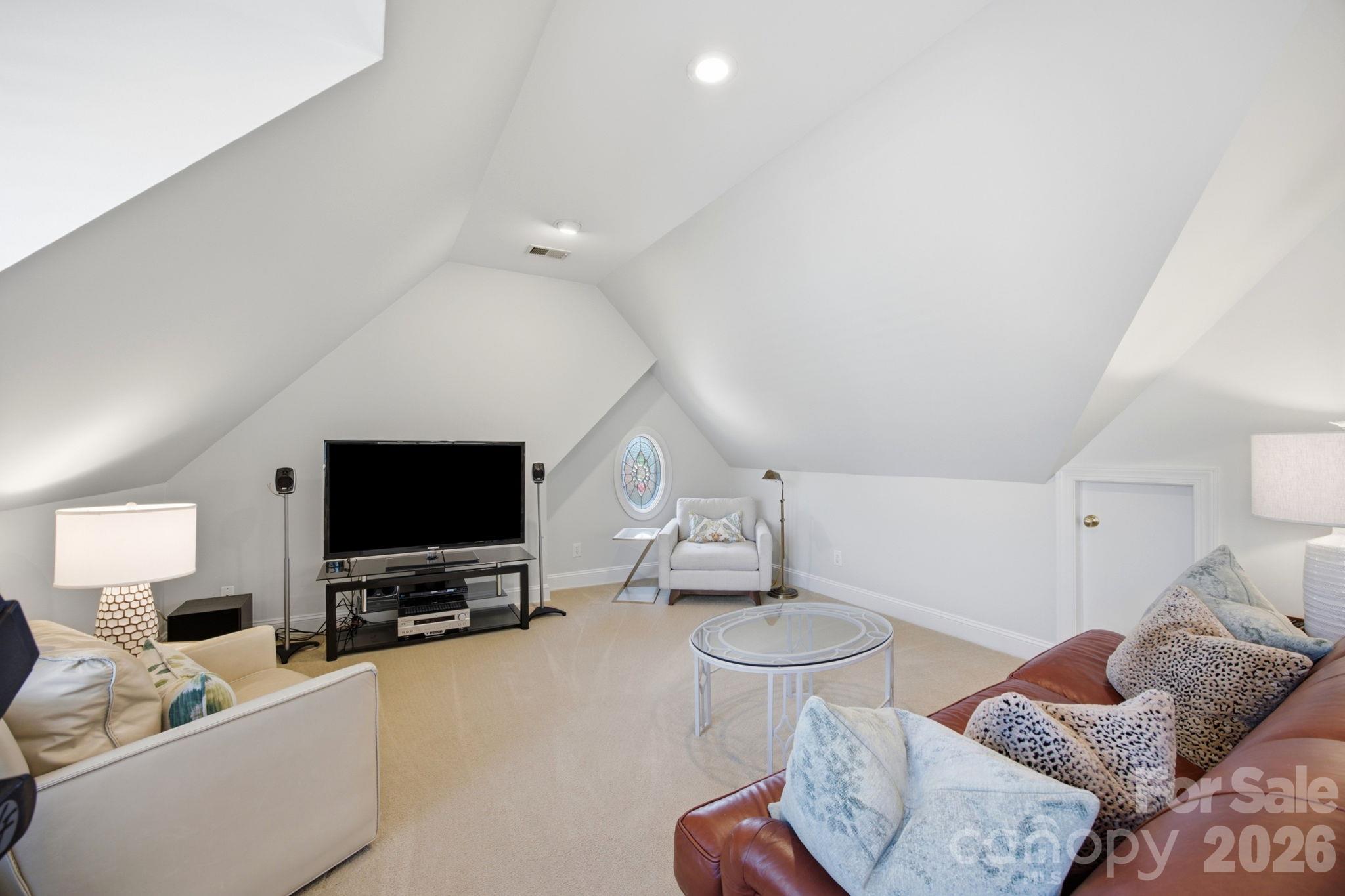 A versatile bonus room ready to adapt as a media lounge, playroom, or hobby space. - 18416 Peninsula Club Drive, Cornelius