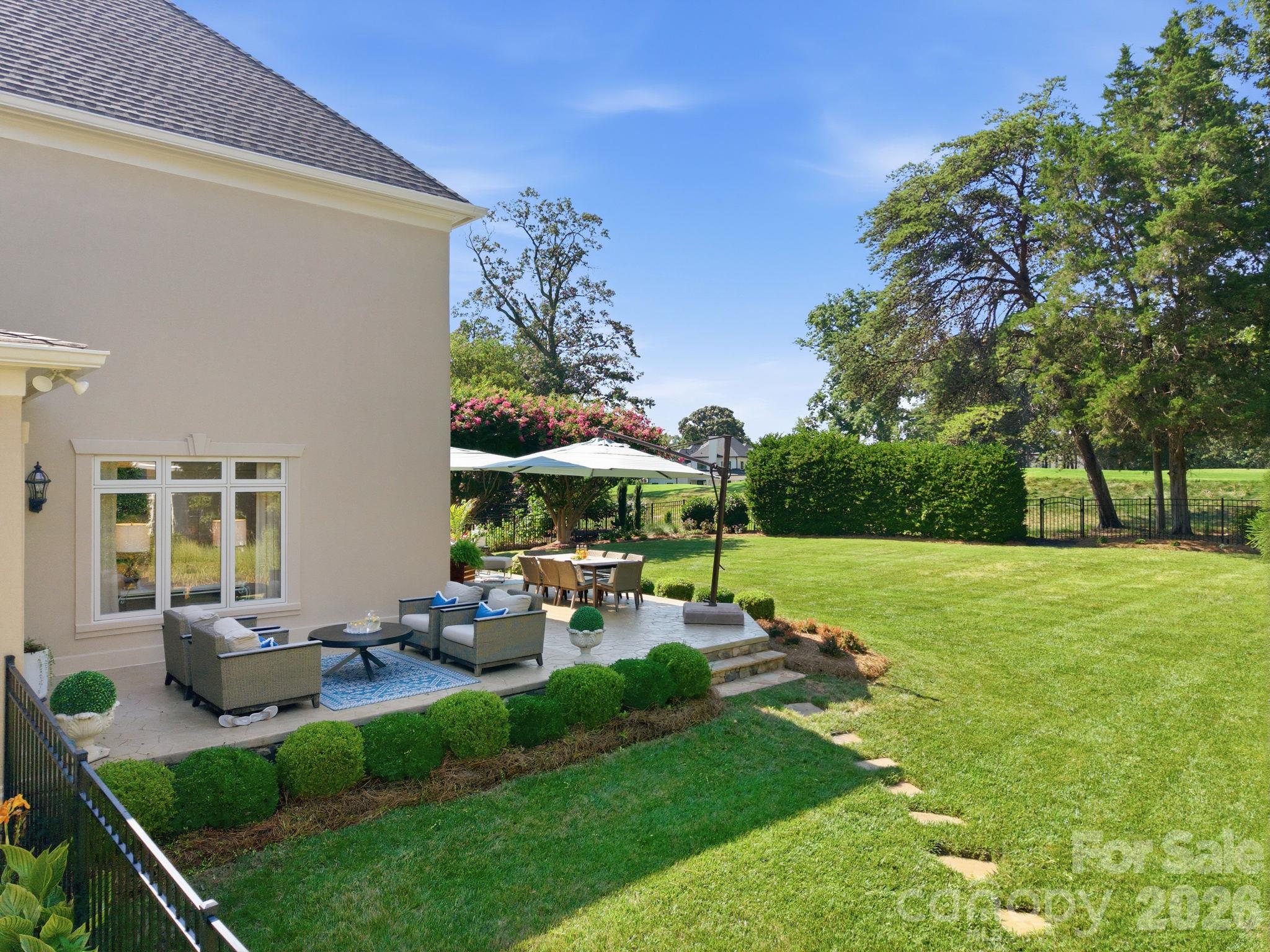 Expansive backyard green space with mature shade trees. - 18416 Peninsula Club Drive, Cornelius