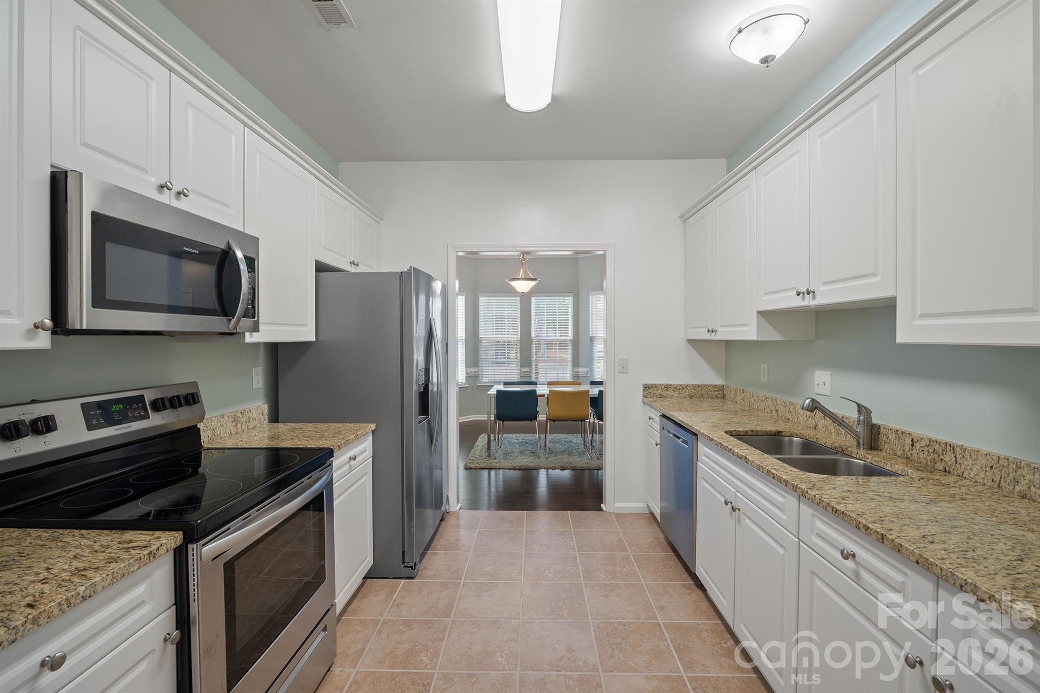 Granite countertops, stainless-steel appliances, lots of cabinets and tile flooring. - 4144 Kenton Glenn Court NW, Concord