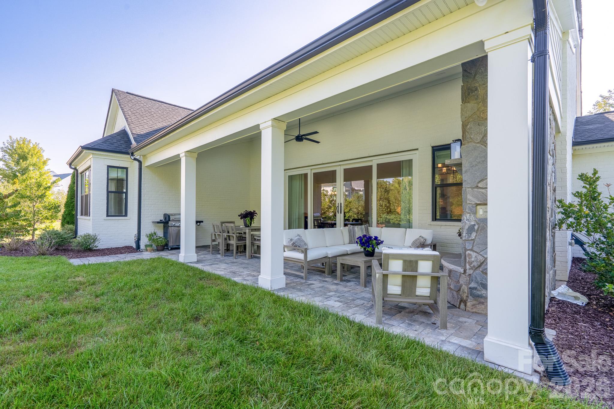 Huge Covered back Porch with Fireplace, Sitting area, Dining area and Grilling. - 9588 Pacing Lane NW, Concord