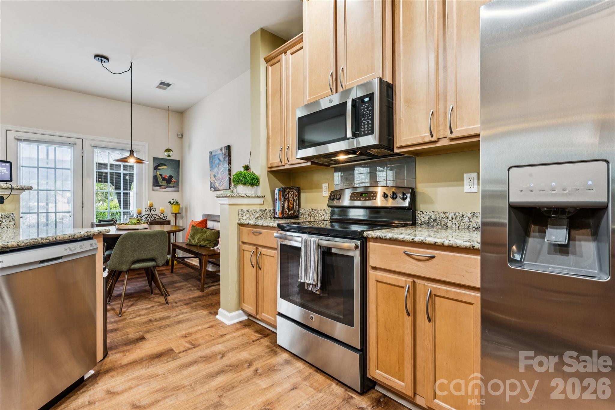Galley-style kitchen with stainless steel appliances - 9506 Birkwood Court, Charlotte